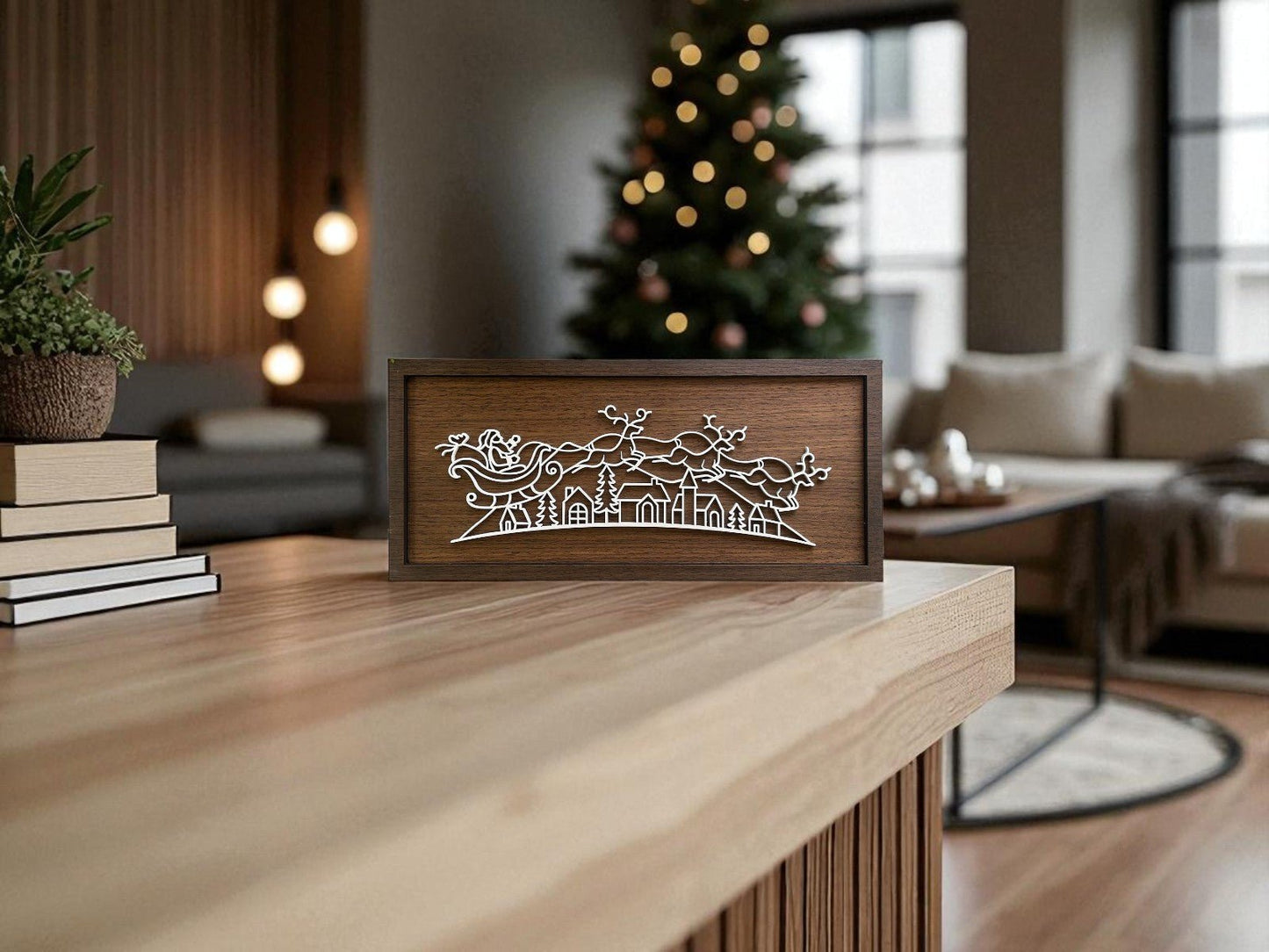 The Santa Sleigh Laser Cut Sign by Mirabilia Boutique features a white silhouette of Santa in his sleigh above houses. Perfect for minimalist holiday decor, it complements cozy spaces with its modern Christmas wall art design.