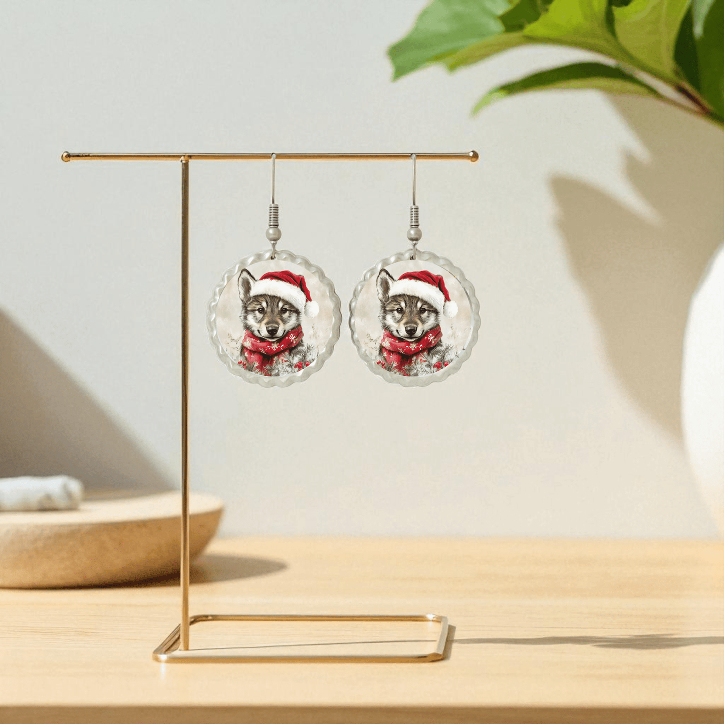 Santa Wolf Earrings by Mirabilia Boutique—woodland Christmas jewelry with wolves in Santa hats and scarves, displayed on gold stand. Hypoallergenic holiday gift for festive style!.