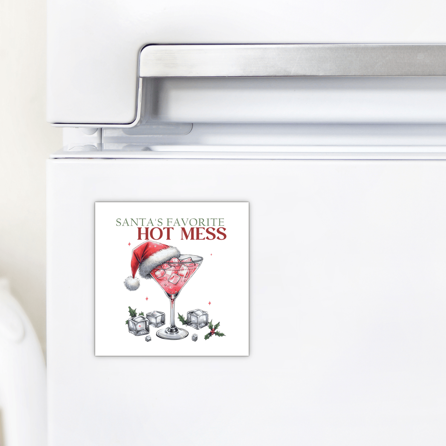 Add festive flair to your kitchen with Mirabilia Boutique’s Santa’s Favorite Hot Mess Magnet—a funny holiday fridge decor featuring a cocktail glass, ice, red drink, and Santa hat. A perfect stocking stuffer!.