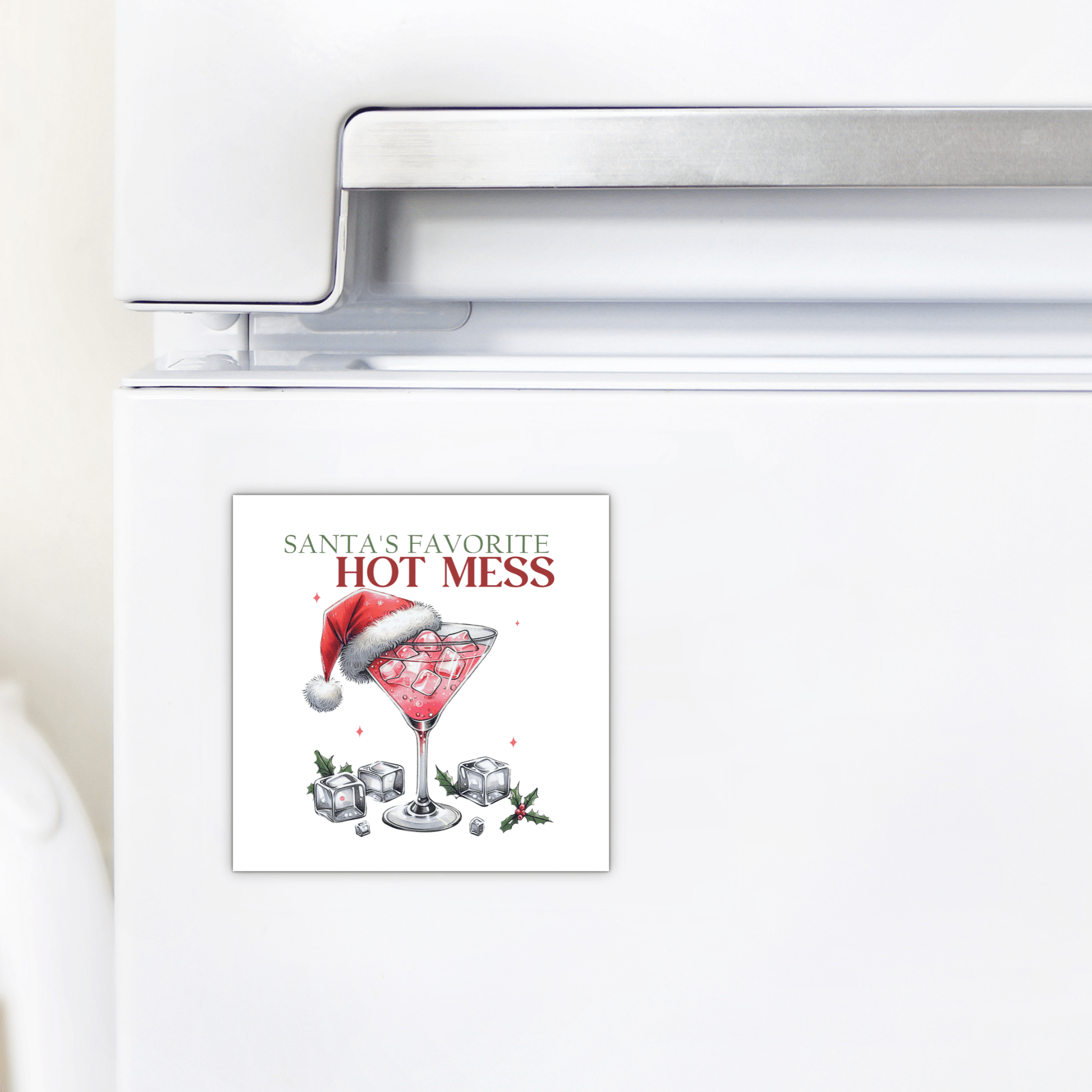 Add festive flair to your kitchen with Mirabilia Boutique’s Santa’s Favorite Hot Mess Magnet—a funny holiday fridge decor featuring a cocktail glass, ice, red drink, and Santa hat. A perfect stocking stuffer!.