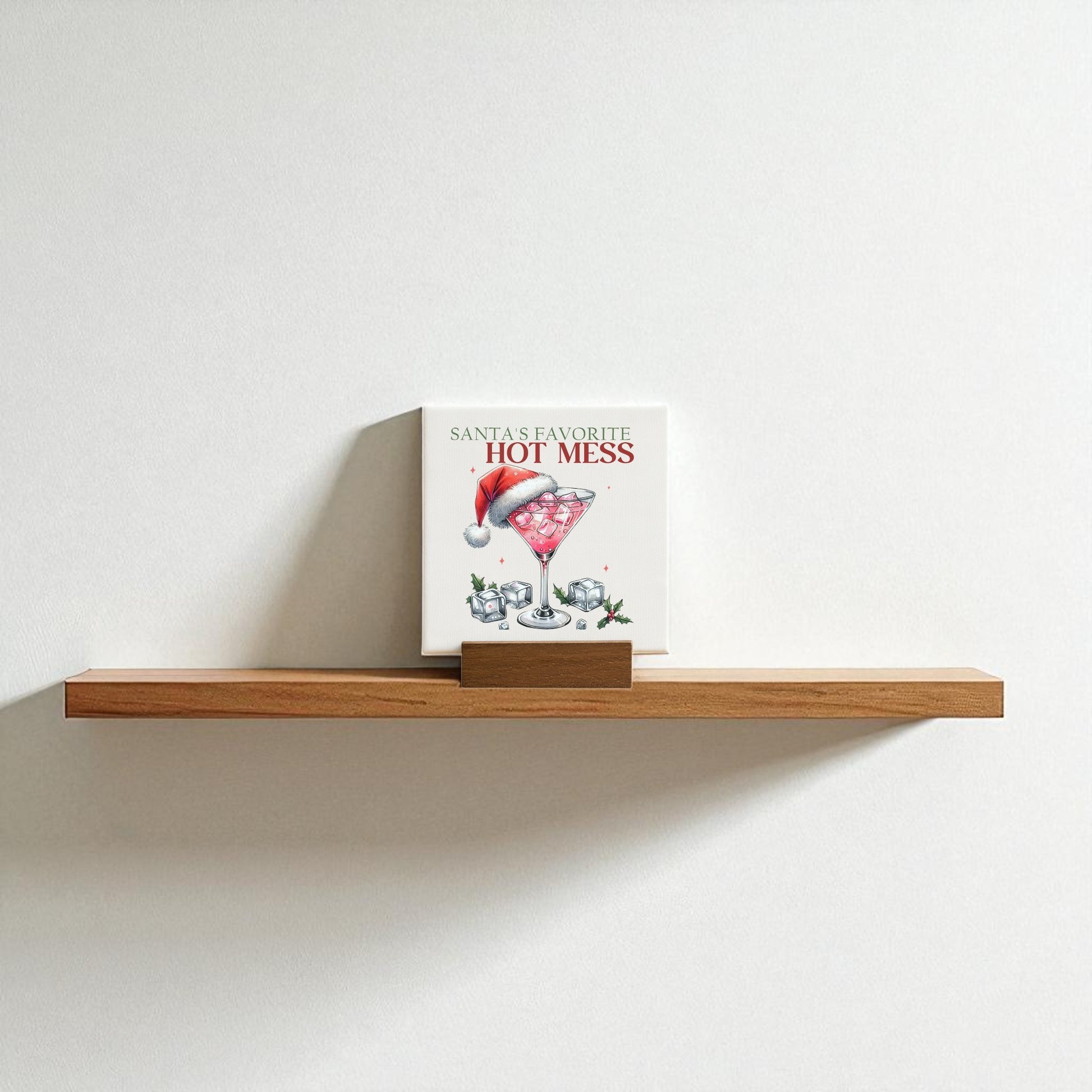 The Santa’s Favorite Hot Mess Mini Sign by Mirabilia Boutique features a festive cocktail glass with a Santa hat, making it the perfect funny holiday decor or playful Christmas bar gift.