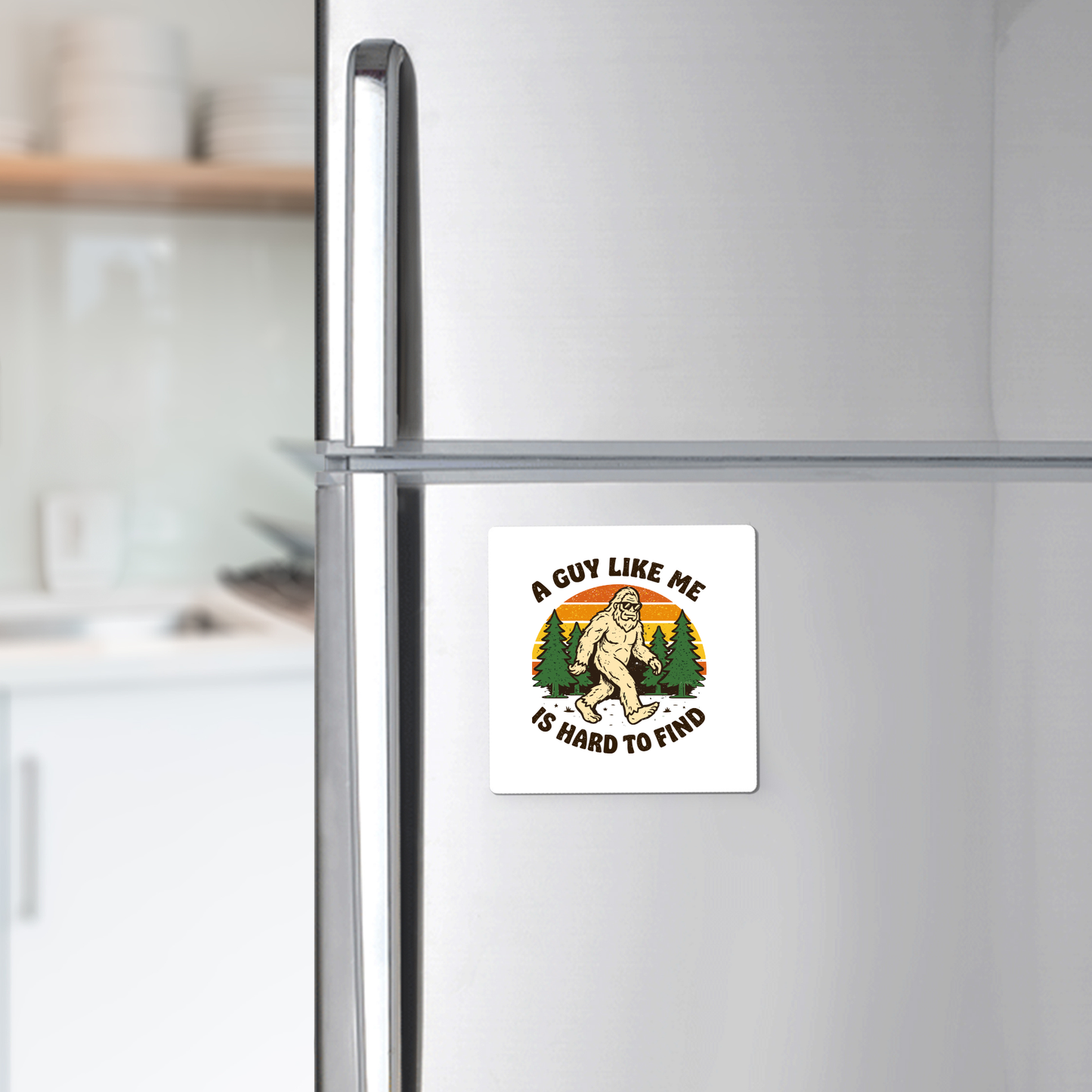 The Funny Bigfoot Magnet by Mirabilia Boutique features “A Guy Like Me Is Hard to Find” and a quirky Sasquatch forest design—perfect for adding unique charm to your fridge decor.