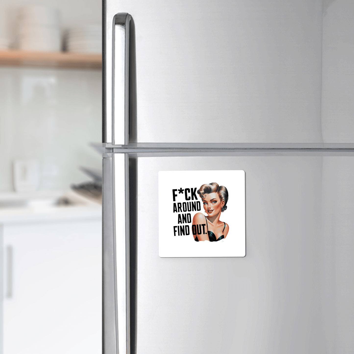 A Mirabilia Boutique “F*ck Around and Find Out” 3x3 retro magnet featuring a smiling woman and bold text, perfect as a sassy gift for friends, coworkers, or office desks. Kitchen background is blurred.