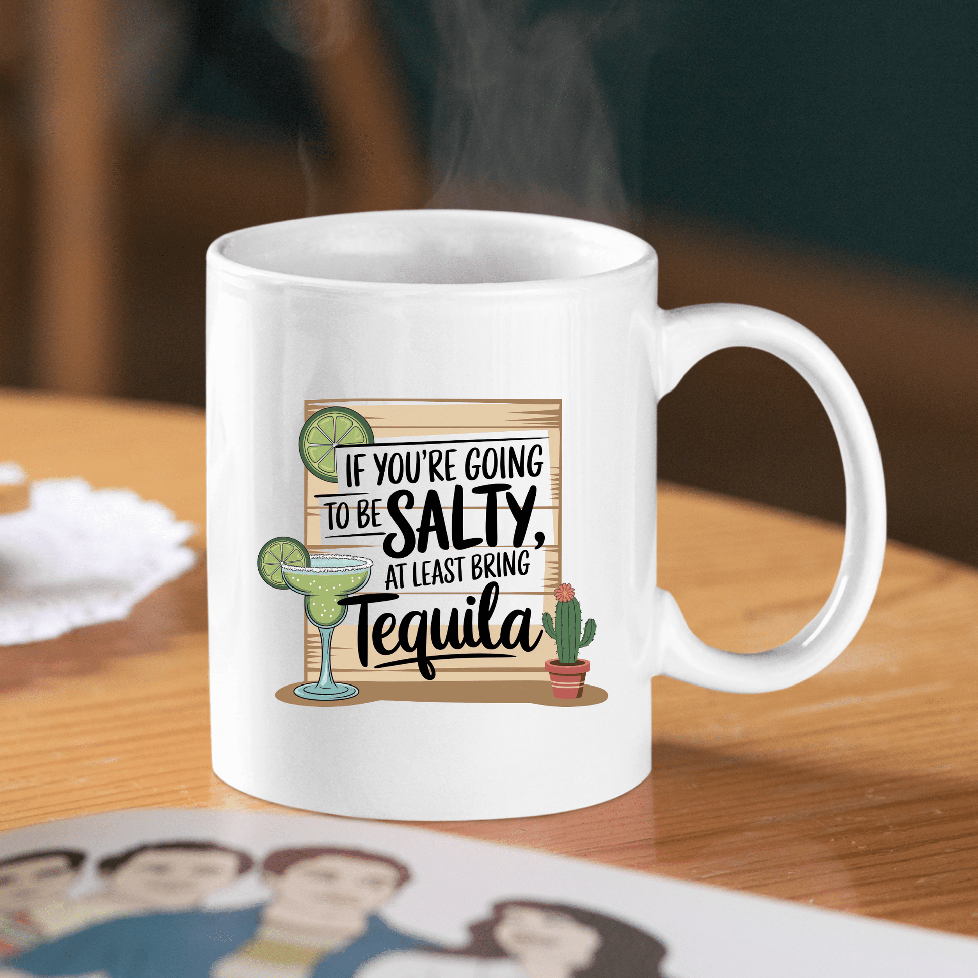 The Salty Tequila Mug – Funny Margarita Quote Coffee Cup by Mirabilia Boutique features a margarita, cactus, and lime with the saying “If you’re going to be salty, at least bring tequila”—perfect for any occasion.