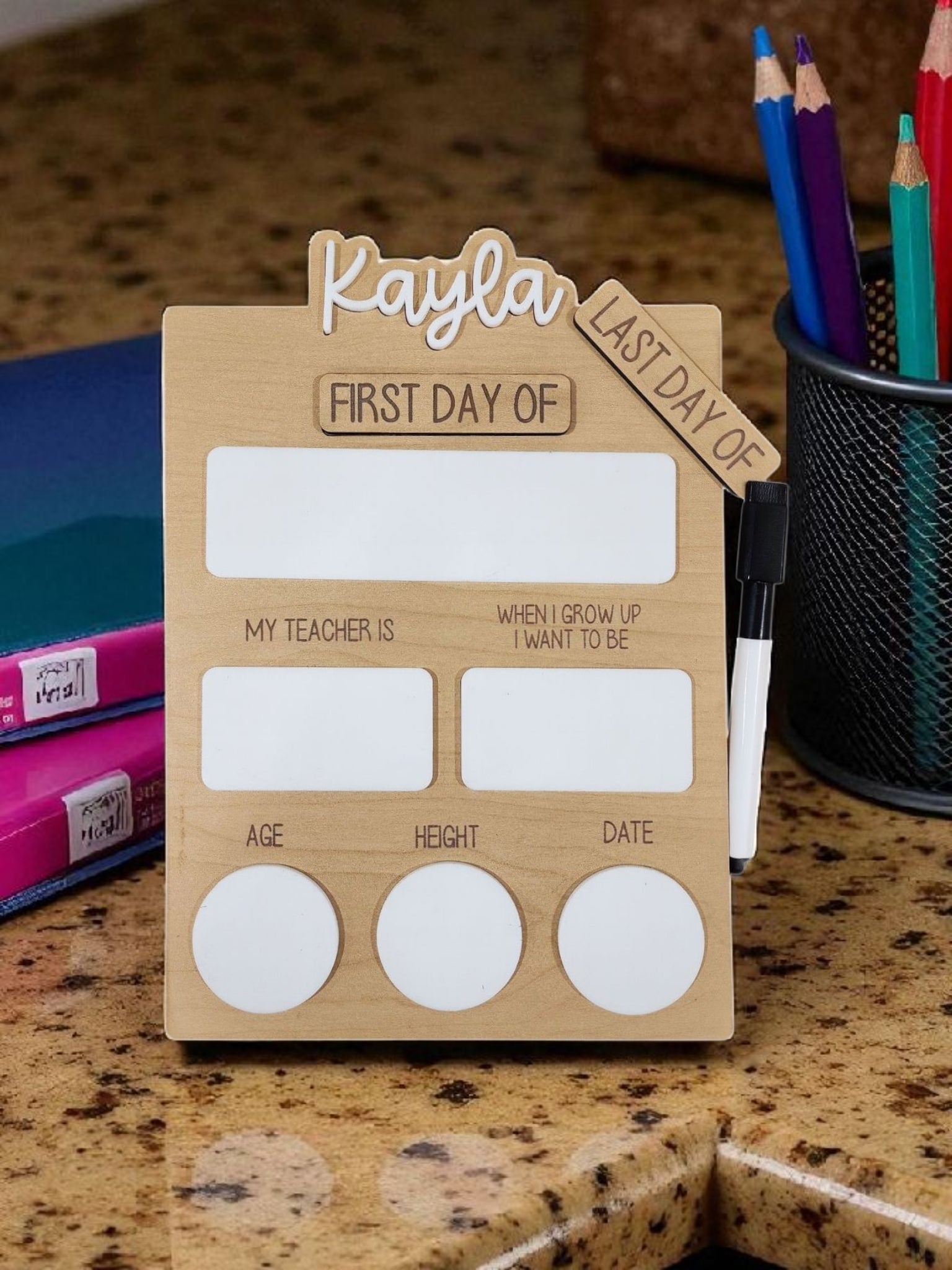 The Mirabilia Boutique Reusable School Board features “First & Last Day of School” sections with space for teacher’s name, aspirations, age, height, and date—a perfect customizable photo prop sign with dry erase marker included.