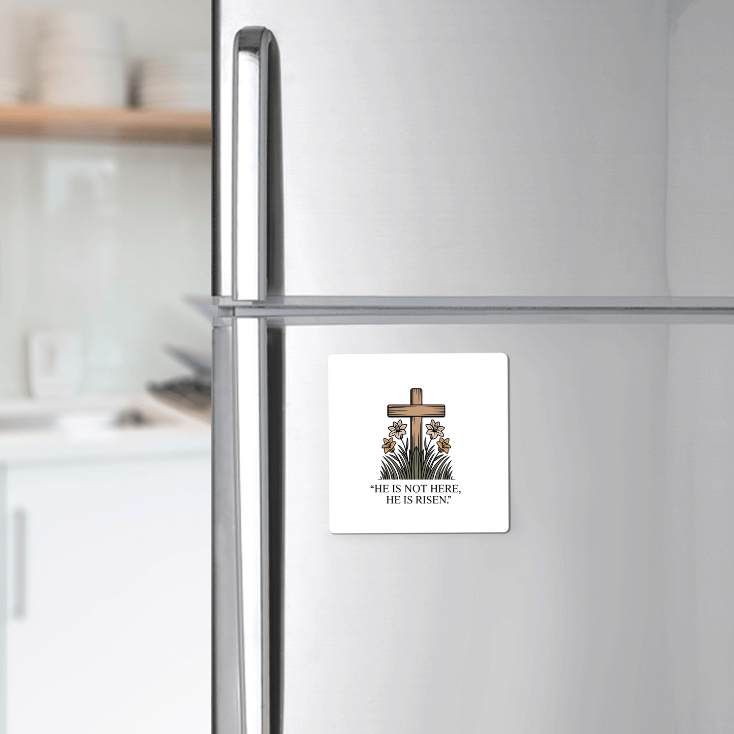 Decorate your fridge with the Mirabilia Boutique He Is Risen Easter Magnet—featuring a wooden cross, lilies, greenery, and “HE IS NOT HERE, HE IS RISEN.” A perfect faith-inspired gift for Easter.