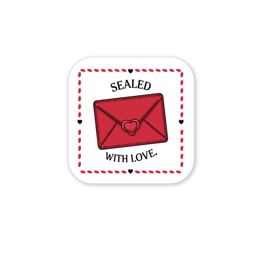 The Sealed with Love Envelope Magnet by Mirabilia Boutique features a red envelope with a heart seal on a white square with a dotted red border, surrounded by "SEALED WITH LOVE." and small hearts—a charming romantic fridge magnet.