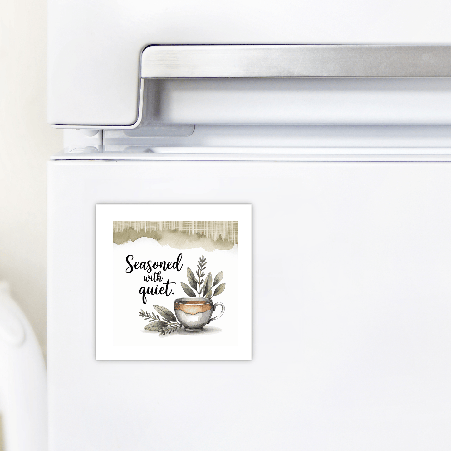 A refrigerator with the Mirabilia Boutique "Seasoned with Quiet" magnet—calm kitchen decor featuring greenery and a watercolor teacup, with charming handwritten text. A perfect mindfulness gift from the Seasoned with Quiet Magnet line.