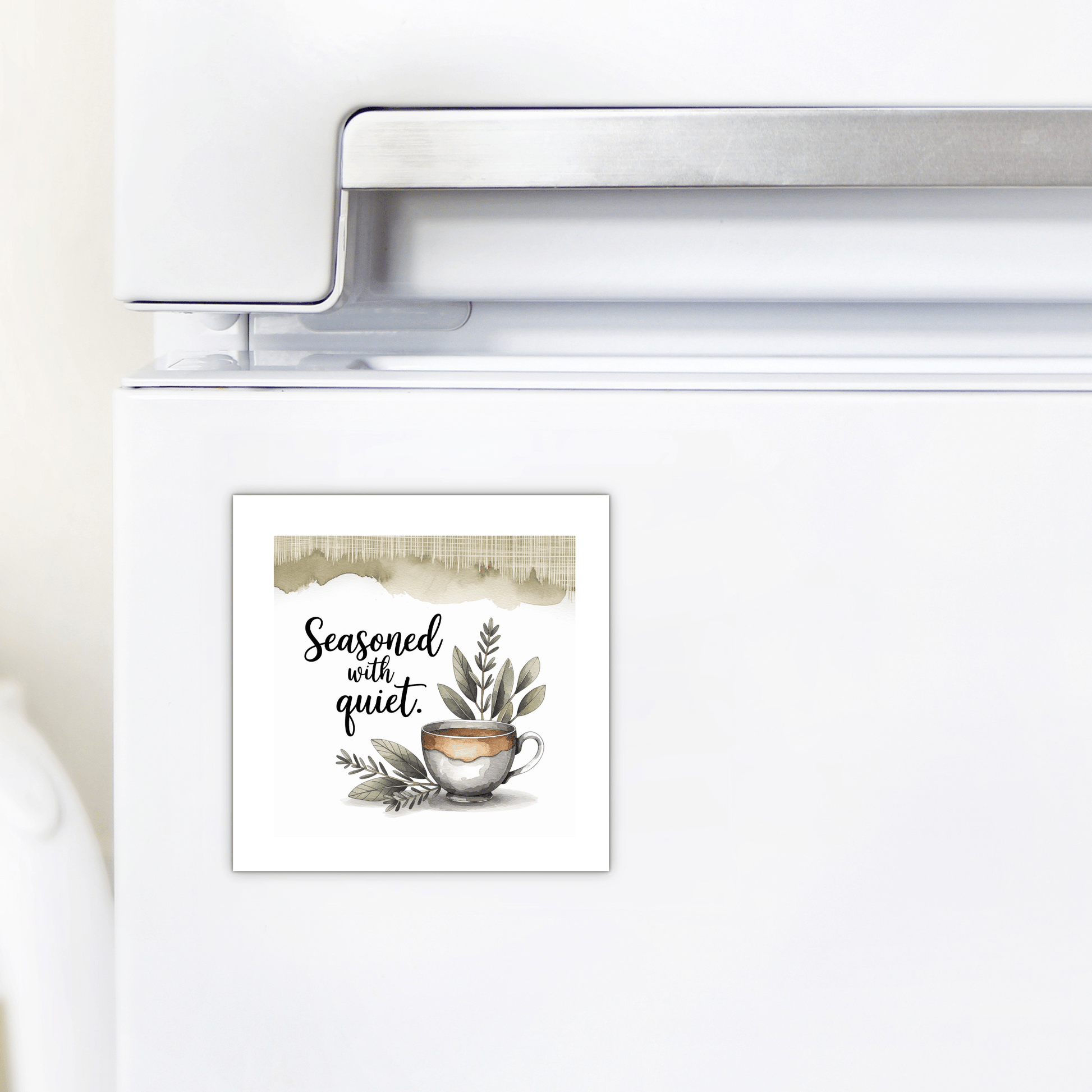A refrigerator with the Mirabilia Boutique "Seasoned with Quiet" magnet—calm kitchen decor featuring greenery and a watercolor teacup, with charming handwritten text. A perfect mindfulness gift from the Seasoned with Quiet Magnet line.