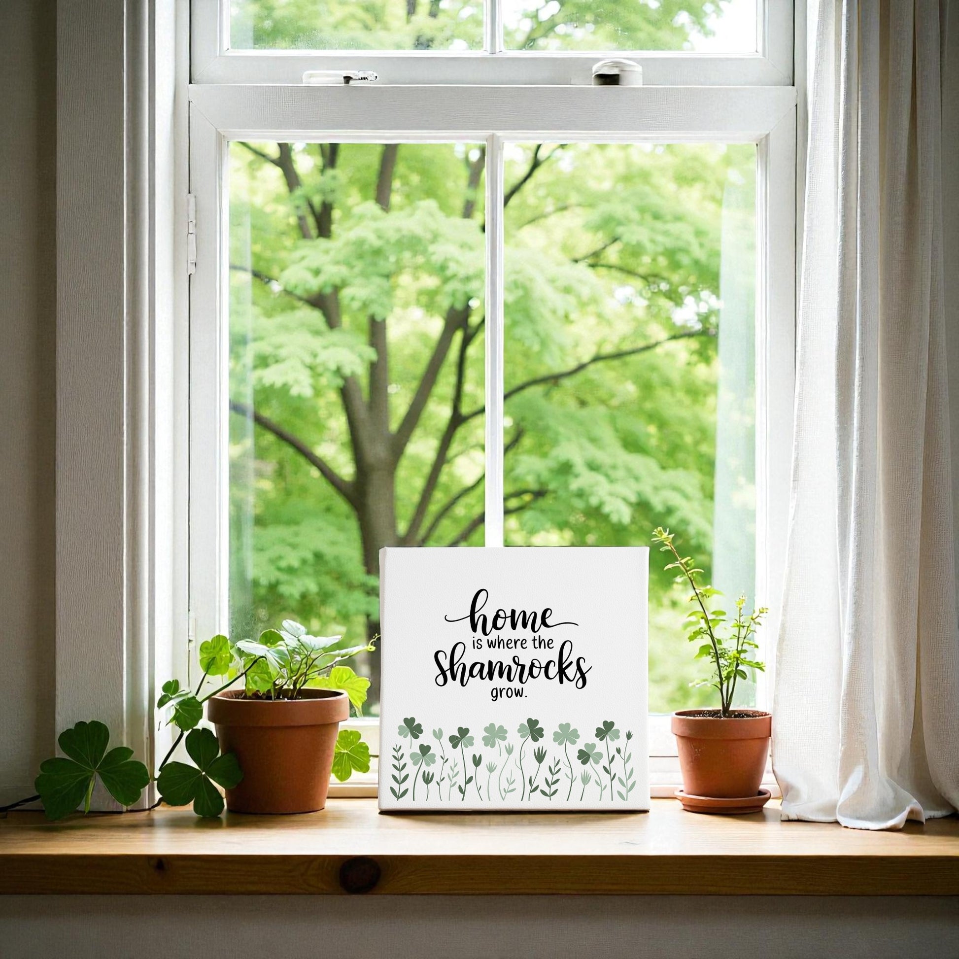 The "Home Is Where the Shamrocks Grow Canvas" by Mirabilia Boutique features a white-framed window with potted shamrocks and a heartwarming sign—a perfect Irish home decor accent for any room.