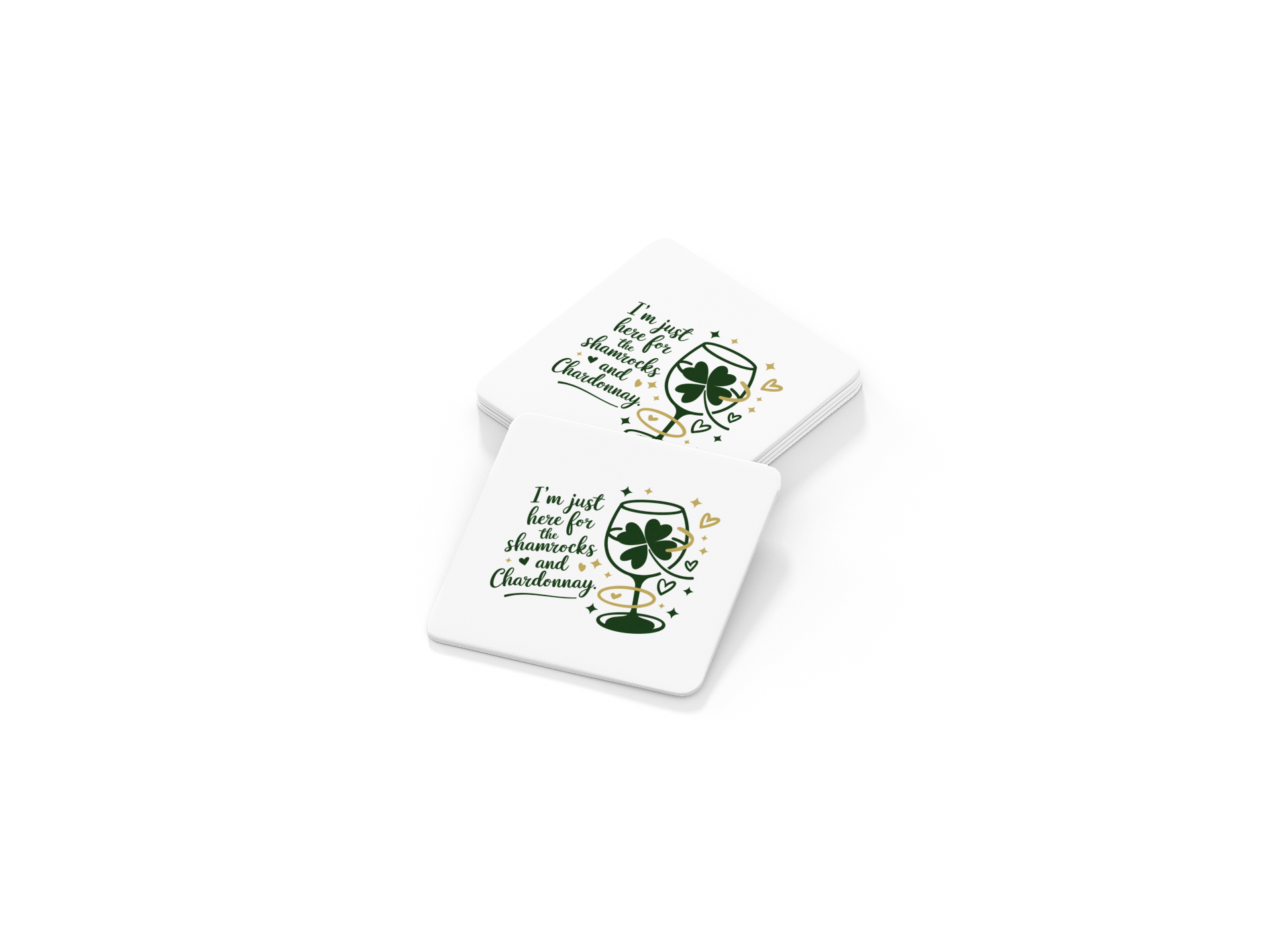 The Shamrocks and Chardonnay Coaster Set by Mirabilia Boutique includes two white St. Patrick’s Day coasters with wine glass, shamrocks, hearts, and the phrase "I'm just here for shenanigans and Chardonnay." Great for wine lovers!.