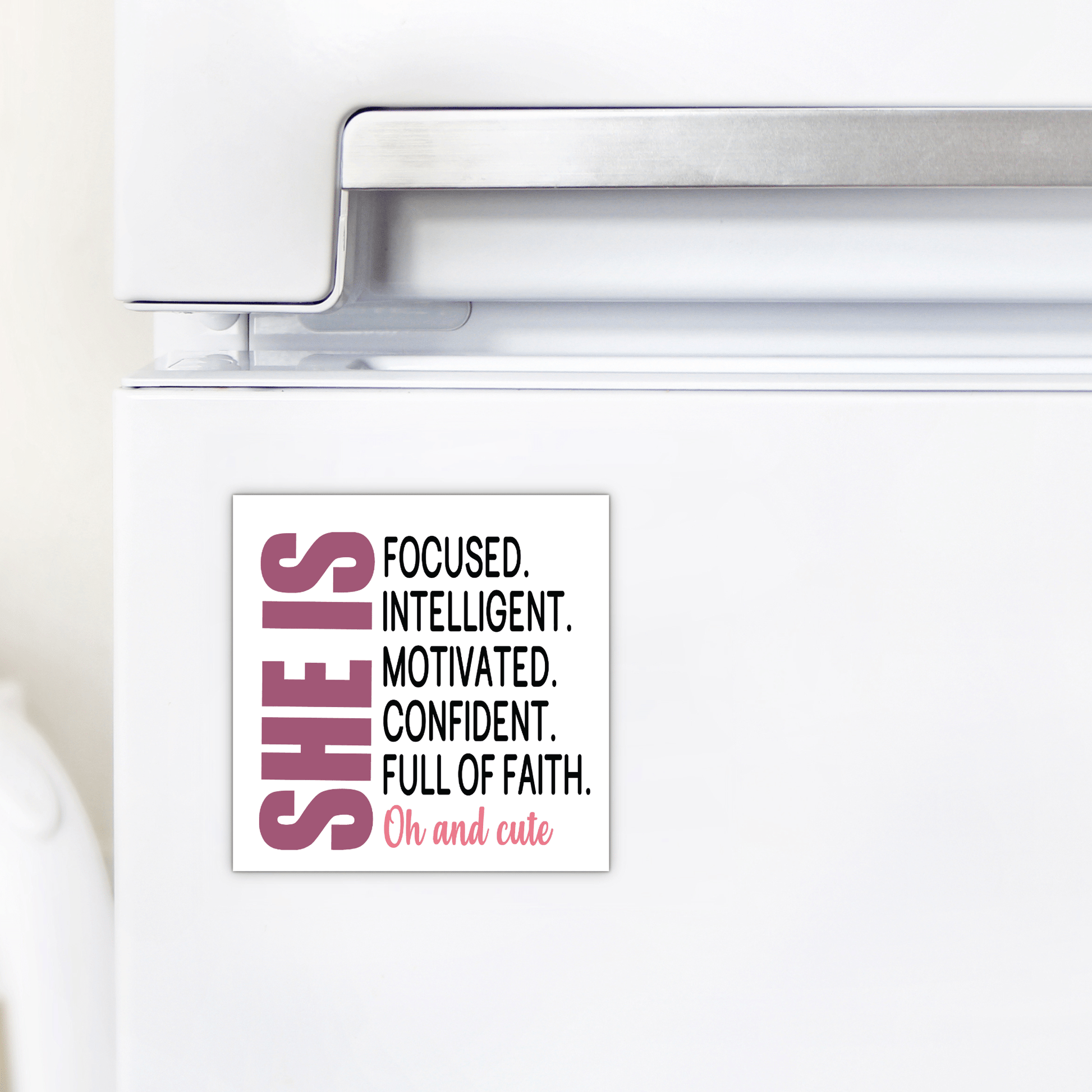 The She Is Motivated & Confident Magnet by Mirabilia Boutique features a black and pink quote: "SHE IS FOCUSED. INTELLIGENT. MOTIVATED. CONFIDENT. FULL OF FAITH. Oh and cute"—an inspiring gift for her.
