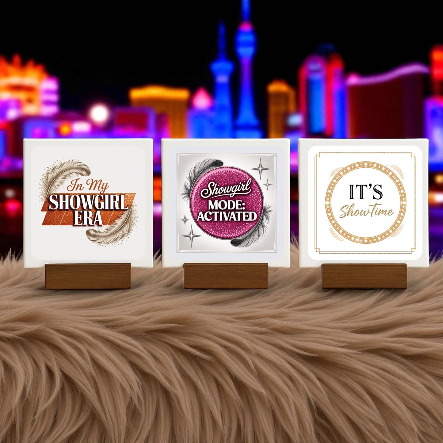 The Showgirl Mini Sign Trio by Mirabilia Boutique features three glamorous signs with chic phrases, displayed on a furry surface and set against neon-lit city vibes. Perfect as glam desk or shelf decor, or a showgirl-inspired gift.