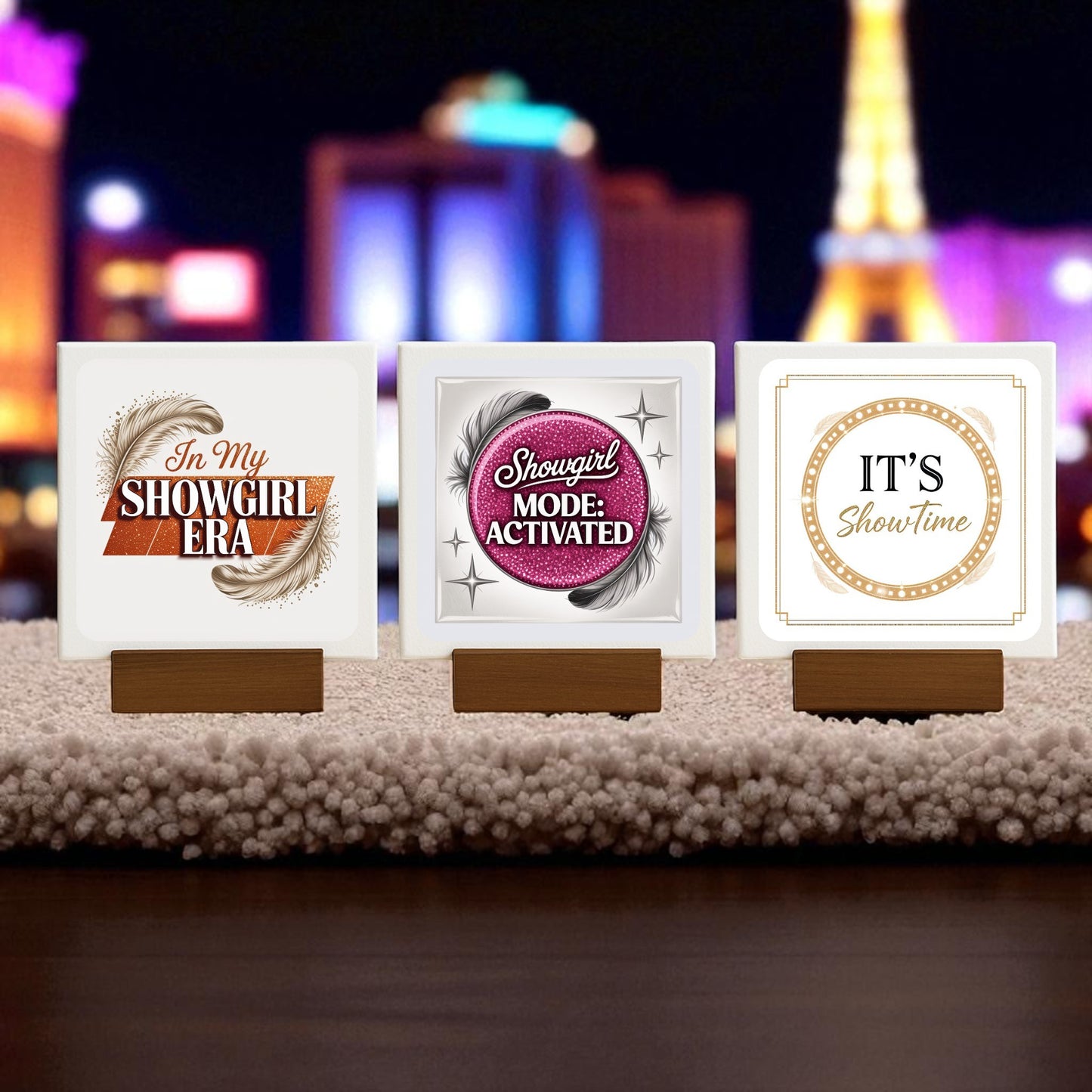 The Showgirl Mini Sign Trio by Mirabilia Boutique features three glam desk or shelf signs—"In My Showgirl Era," "Showgirl Mode: Activated," and "IT'S Showtime"—each on a wooden stand, perfect for adding chic flair to any textured surface.