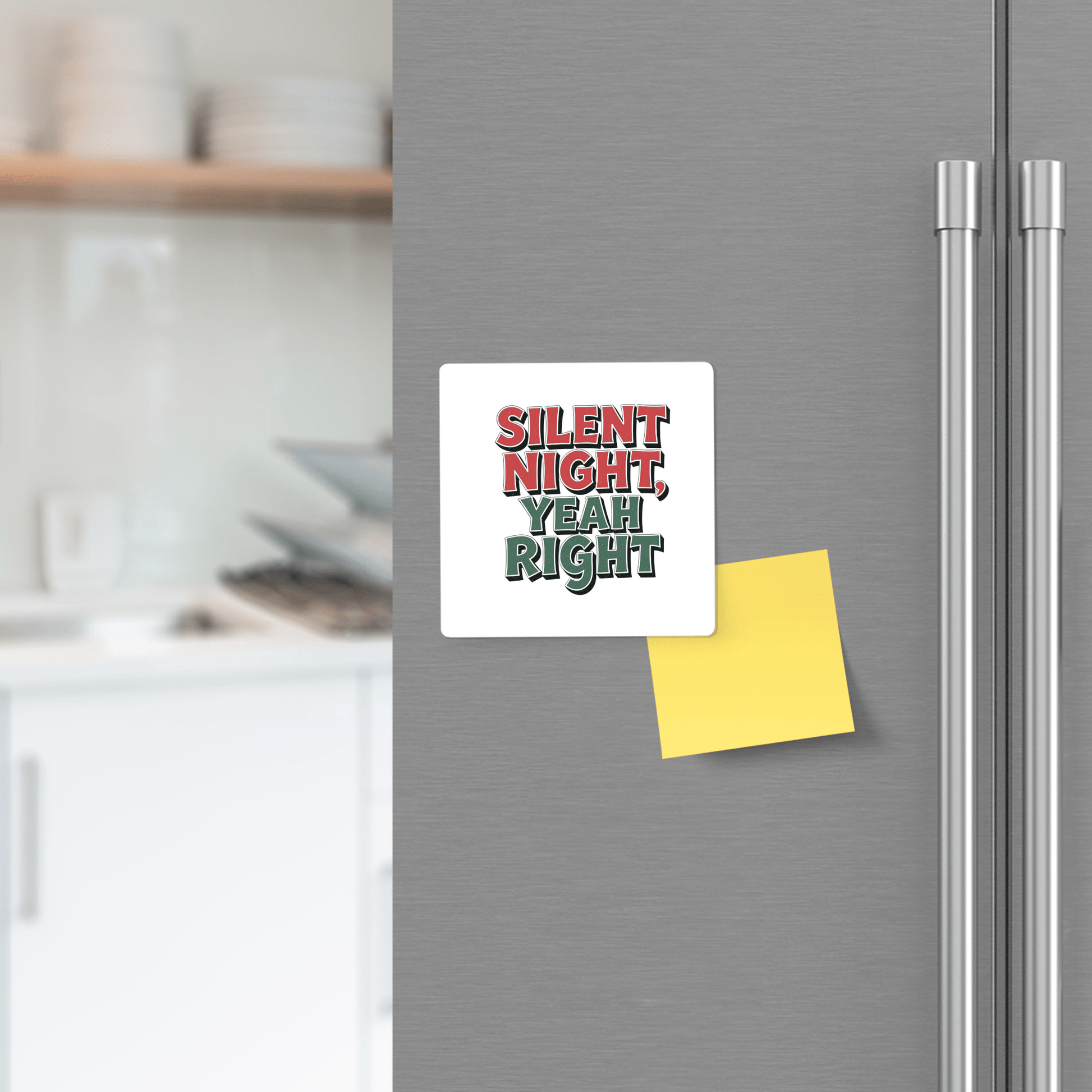 A Silent Night Yeah Right Magnet by Mirabilia Boutique, reading "SILENT NIGHT, YEAH RIGHT" in festive red and green, adds humor to the fridge—perfect as a funny holiday fridge decor or stocking stuffer. A yellow sticky note and kitchen shelves enhance the scene.