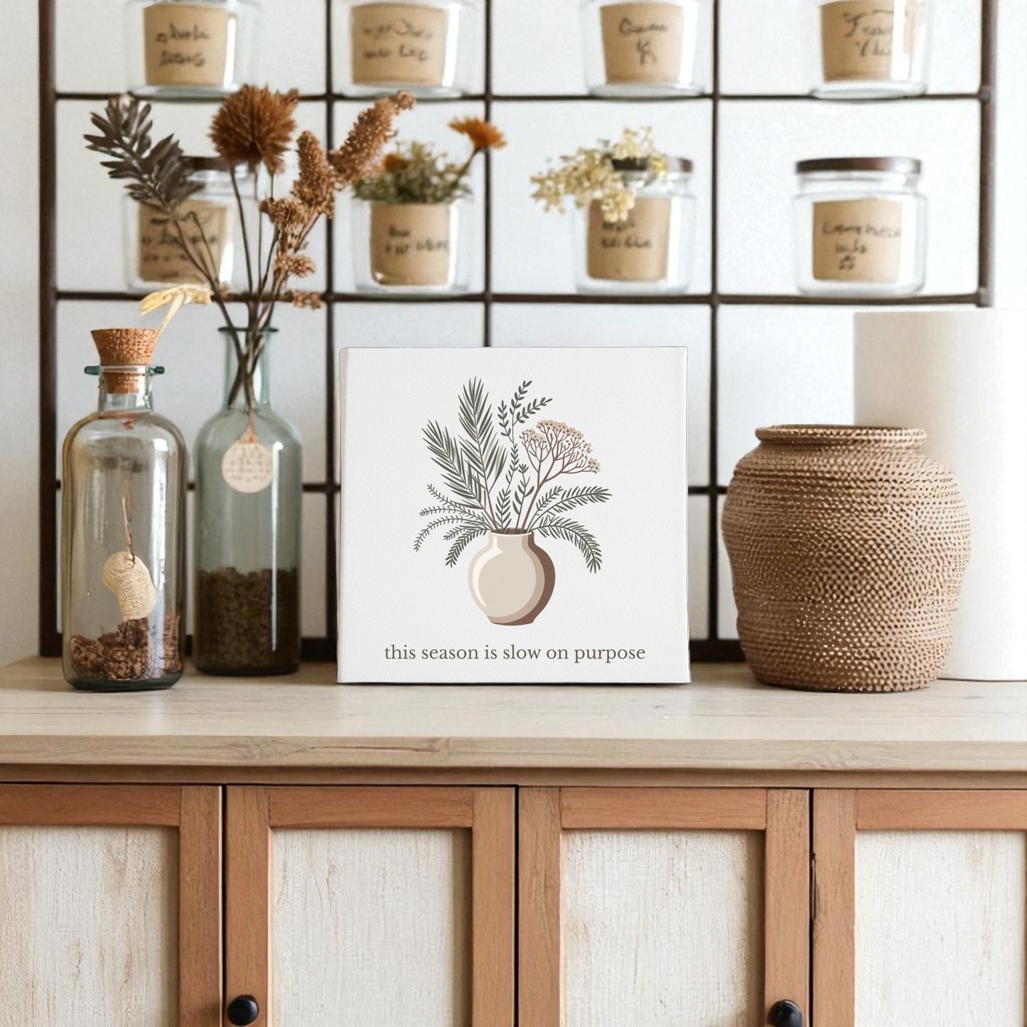The Slow on Purpose Canvas | Botanical Vase Quote Wall Art by Mirabilia Boutique, styled with decorative jars and dried flowers, inspires intentional living in any space.