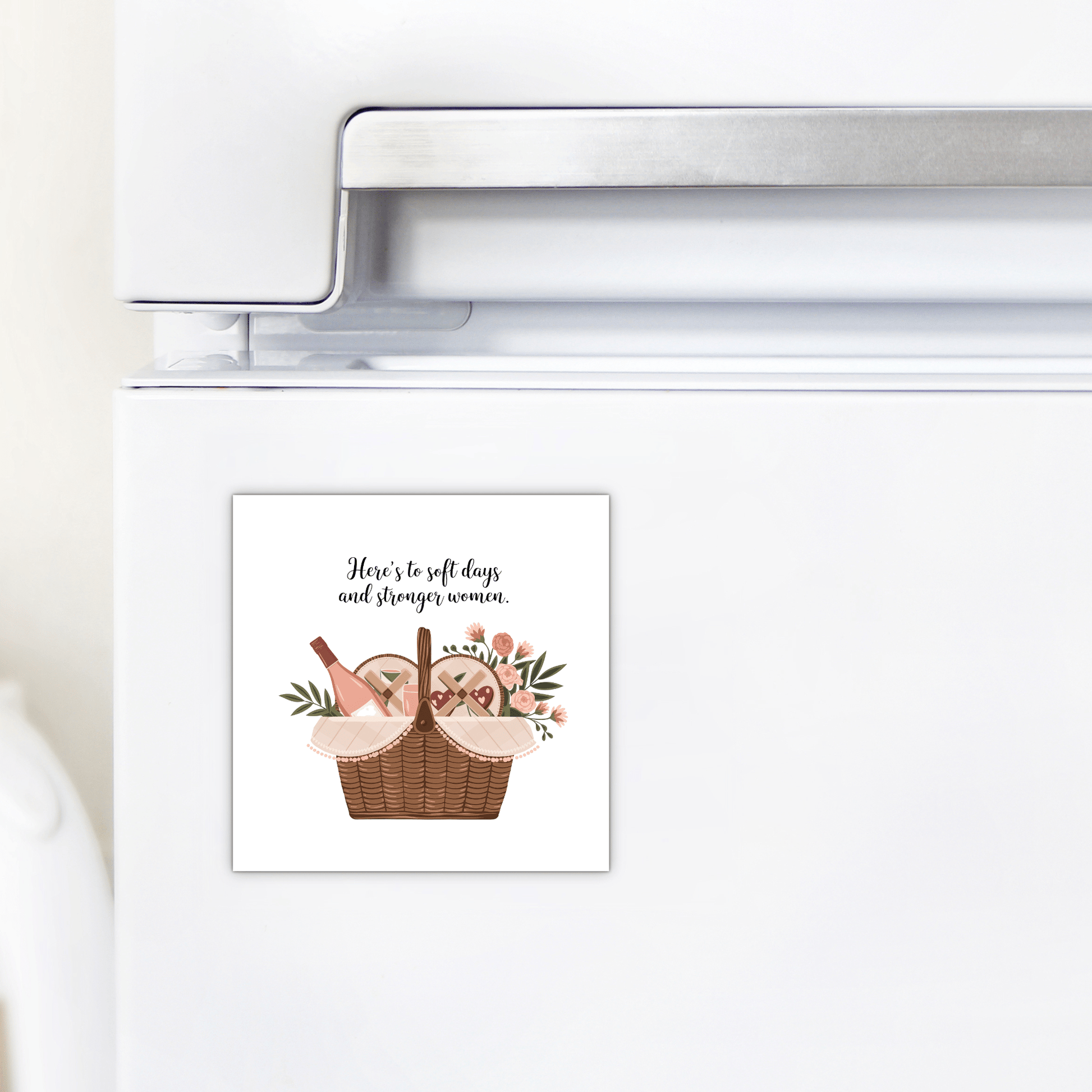 The Mirabilia Boutique Soft Days Strong Women Magnet is a square gift for women, featuring a picnic basket with flowers, bread, wine, and the quote: "Here's to soft days and stronger women." Perfect for inspiration and empowerment.