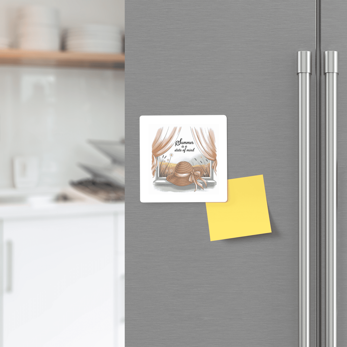 A Mirabilia Boutique "Summer Is a State of Mind" magnet featuring a sunhat decorates the fridge door, alongside a yellow sticky note. A modern kitchen with white shelves is visible in the background.