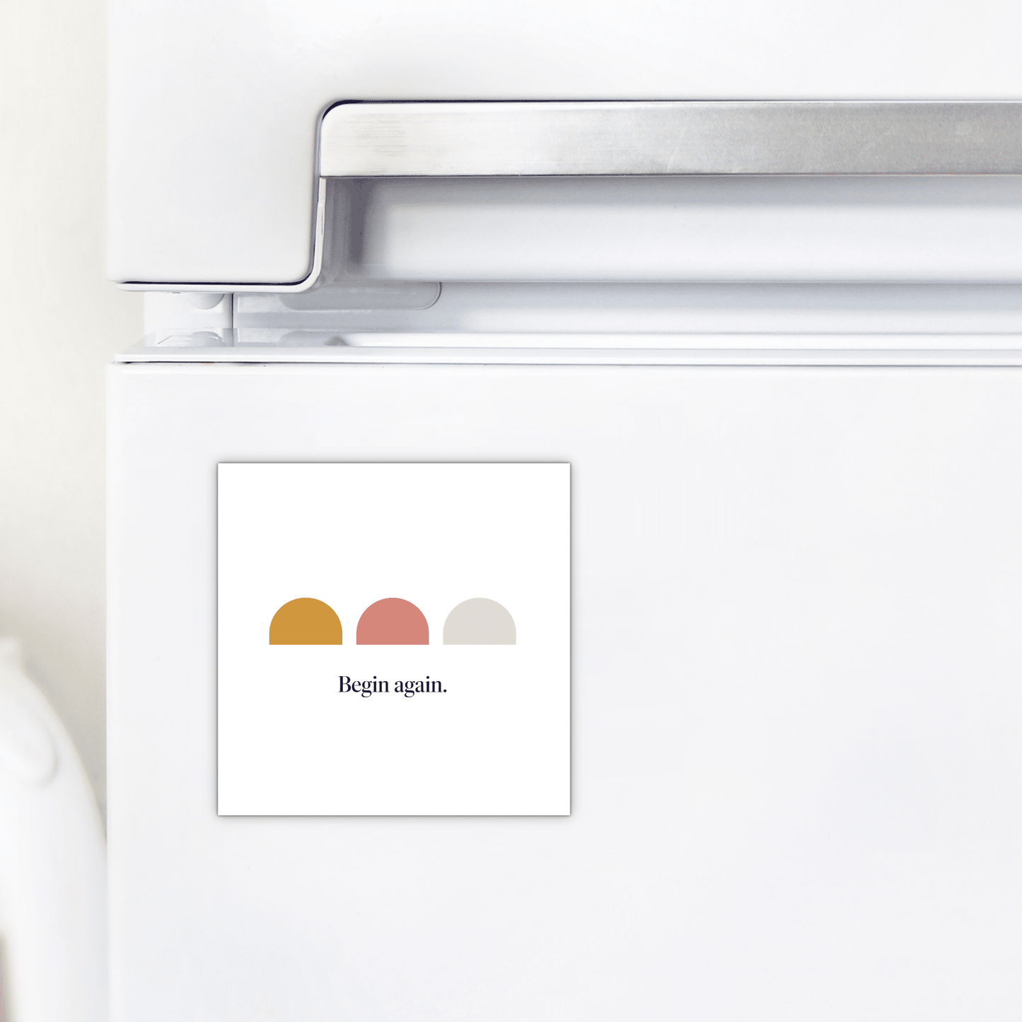 The Begin Again Magnet – Minimalist Summer Affirmation by Mirabilia Boutique features three colored semicircles and the phrase "Begin again."—a stylish, motivational accessory for your fridge.