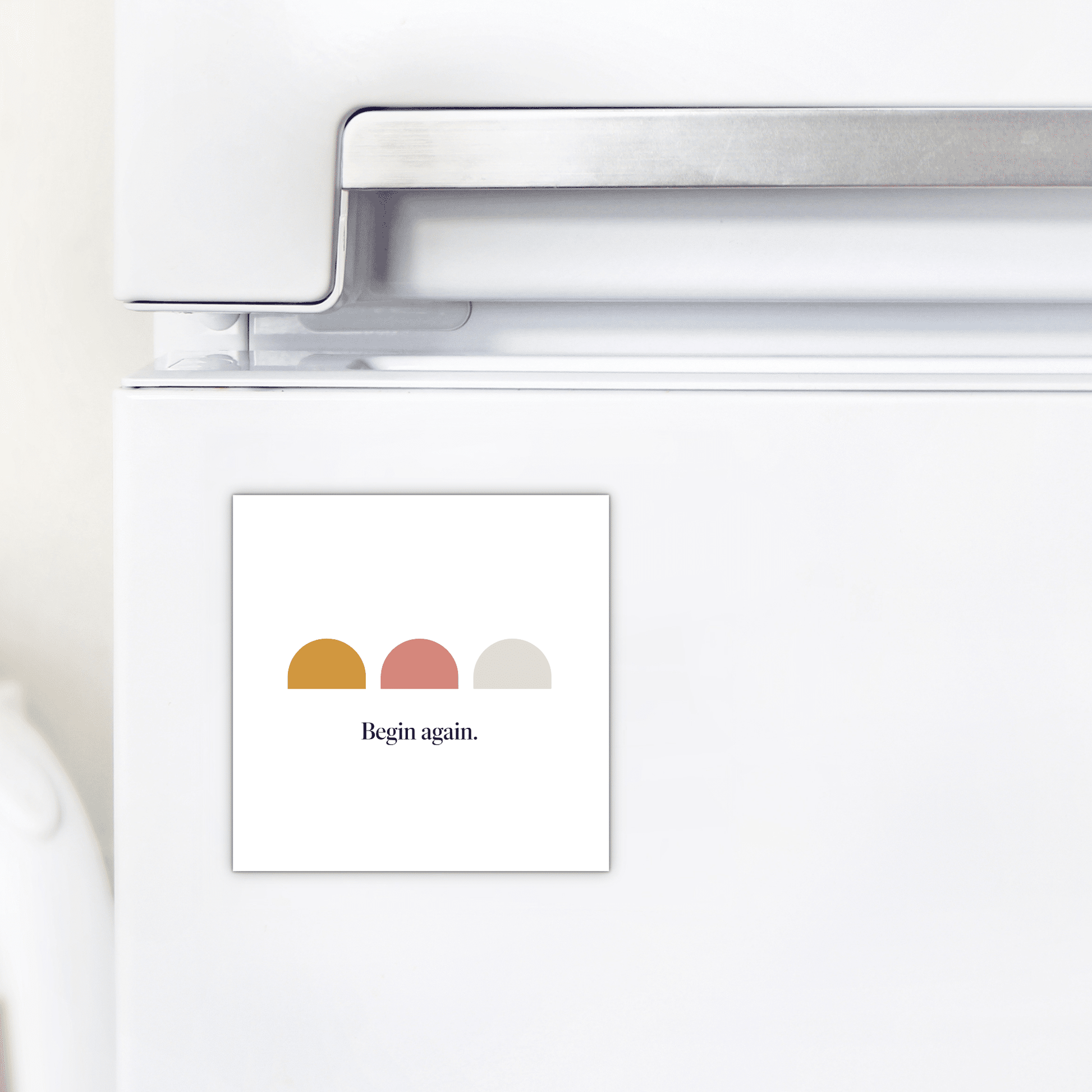 The Begin Again Magnet – Minimalist Summer Affirmation by Mirabilia Boutique features three colored semicircles and the phrase "Begin again."—a stylish, motivational accessory for your fridge.