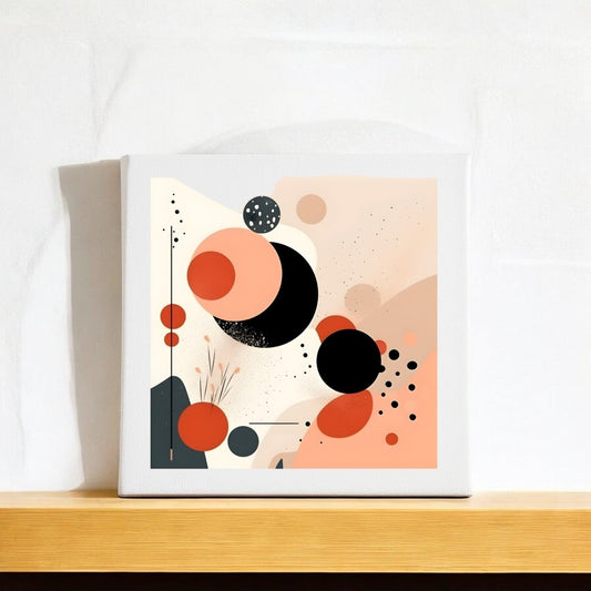 The Solar Bloom Mid Century Modern Canvas by Mirabilia Boutique showcases abstract overlapping circles in black, peach, and orange with minimalist dots and lines, displayed on a wooden shelf against a white textured wall.