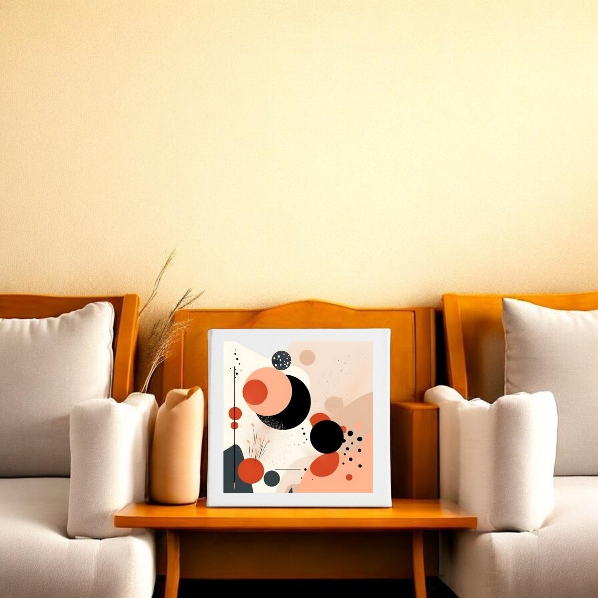 The Solar Bloom Mid Century Modern Canvas by Mirabilia Boutique, featuring geometric shapes in black, orange, and beige, is framed and displayed on a wooden coffee table between two cushioned armchairs against a light yellow wall.