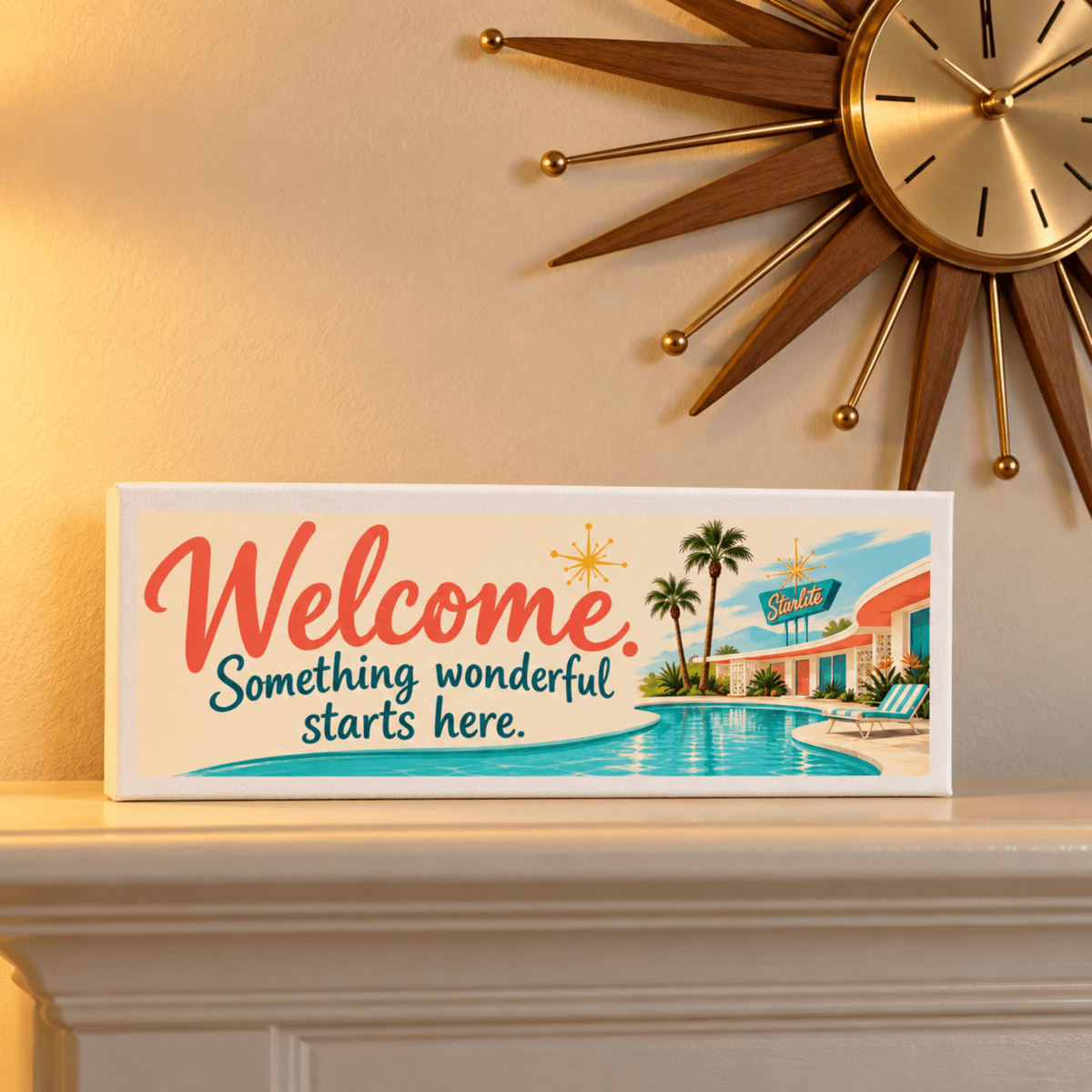 A Welcome, Something Wonderful Starts Here Shelf Sitter | Chrome & Starlight displayed on a mantel below a starburst wall clock, featuring a mid-century modern motel pool illustration.