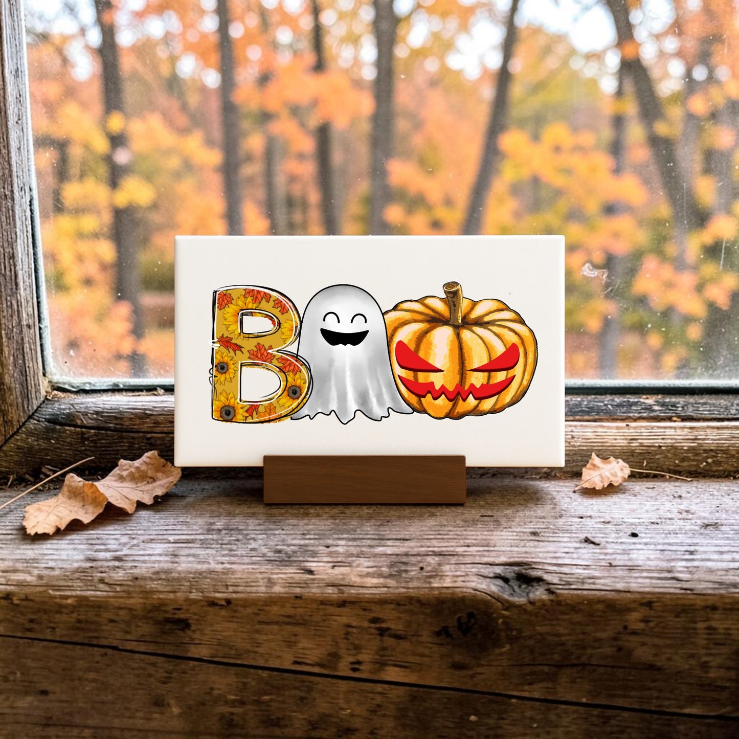 The BOO Ghost Pumpkin Mini Sign by Mirabilia Boutique features a decorated B, smiling ghost O, and pumpkin O—perfect Halloween shelf decor. Set on your windowsill with autumn leaves outside for a festive seasonal touch.