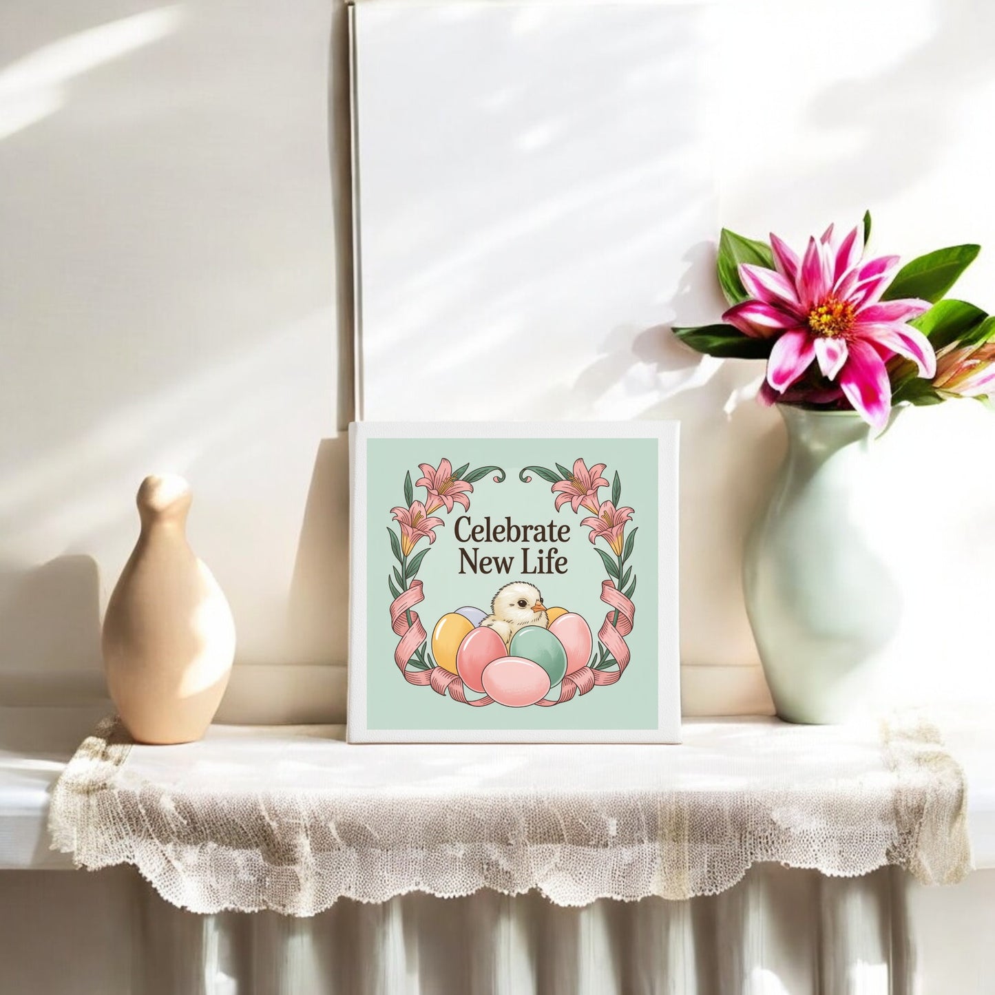 The Celebrate New Life Spring Chick Canvas Art by Mirabilia Boutique features pastel eggs, a chick, and flowers with festive text—an ideal Easter decoration for your table or mantel.