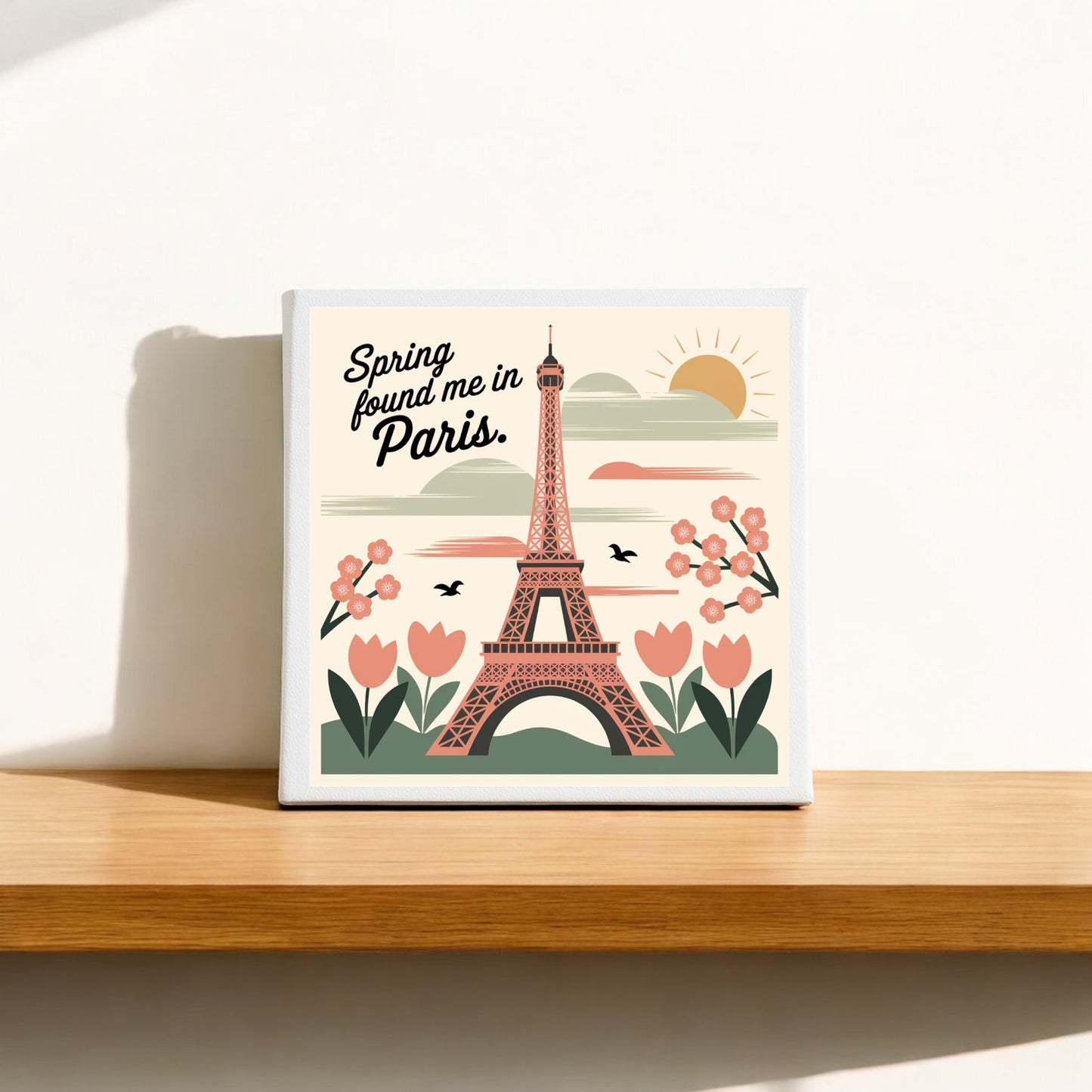 The Mirabilia Boutique "Spring Found Me in Paris – Eiffel Tower Art Canvas" features a colorful Eiffel Tower with pink flowers, green leaves, birds, and a sun—perfect spring-inspired wall art for your space.