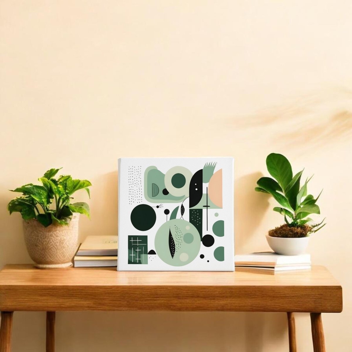 A wooden table with two potted plants, stacked books, and the "Spring Geometry Mid Century Modern Canvas" by Mirabilia Boutique in green and black tones displayed on a beige wall.