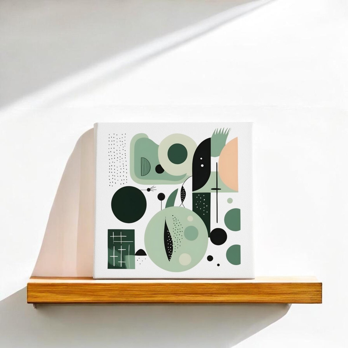 The Spring Geometry Mid Century Modern Canvas by Mirabilia Boutique features green, black, and beige geometric shapes displayed on a wooden shelf against a sunlit white wall, evoking a stylish modern abstract look.
