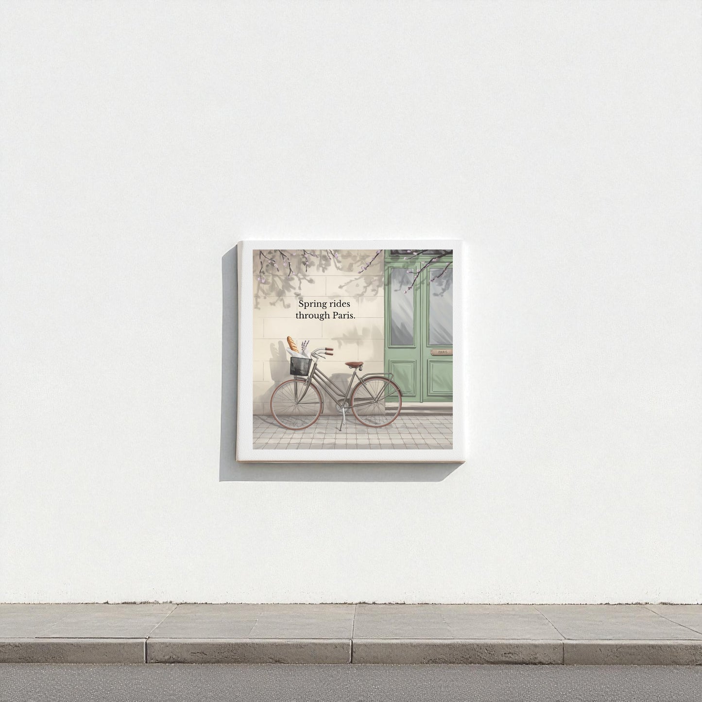 Mirabilia Boutique's "Spring Rides Through Paris Canvas Art" features a vintage bicycle by a green door, minimalist Paris scene, and the phrase “Spring rides through Paris”—ideal spring wall decor for any space.