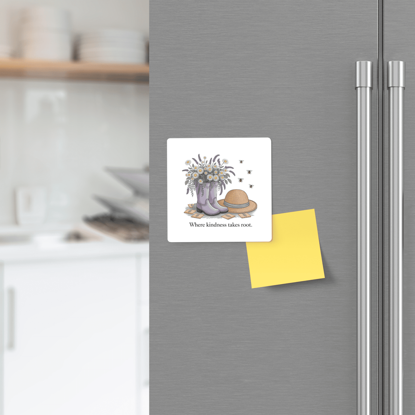 The Kindness Garden Magnet – Floral Boots & Bees Quote by Mirabilia Boutique brings charm to any gray fridge beside a yellow sticky note—a lovely kitchen accent and perfect kindness gift.