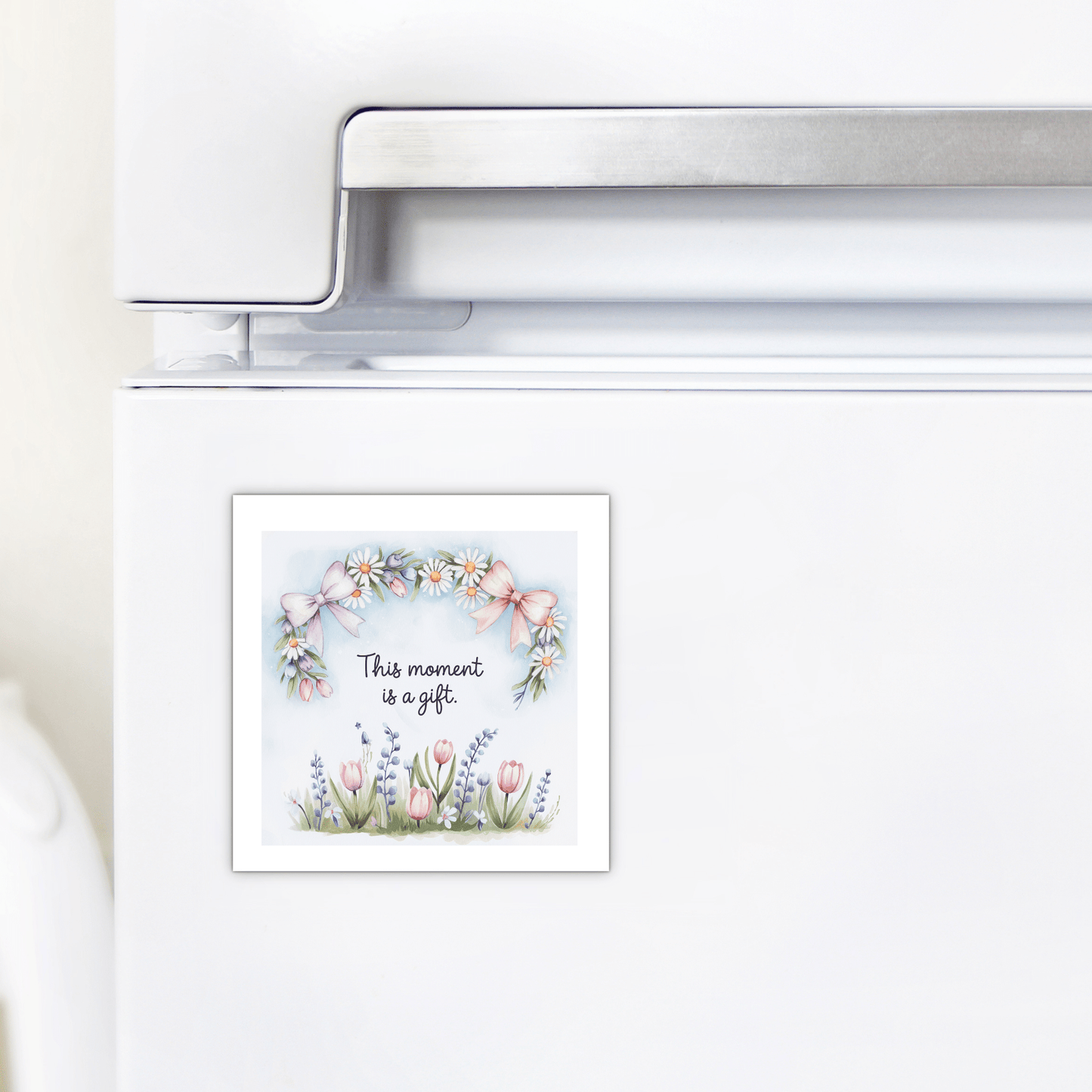 The Mirabilia Boutique “This Moment Is a Gift Magnet – Floral Spring Quote” features pastel daisies, tulips, lavender, and pink bows—an inspirational mindfulness gift for any home fridge.
