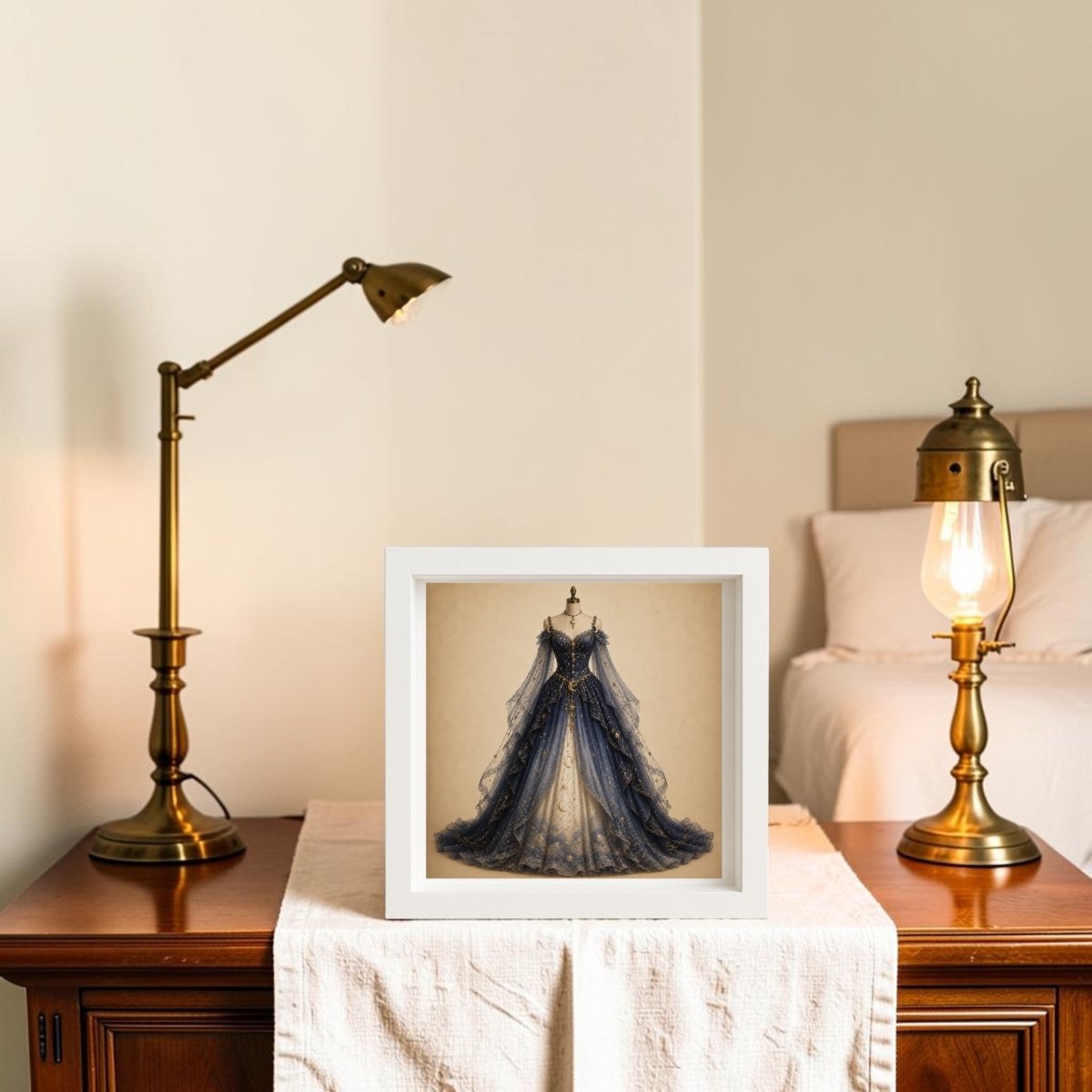 A framed Moonlit Symphony | Curated Couture Artwork by Mirabilia Boutique in ornate blue and gold sits on a wooden table between two brass lamps, creating a cozy bedroom setting.