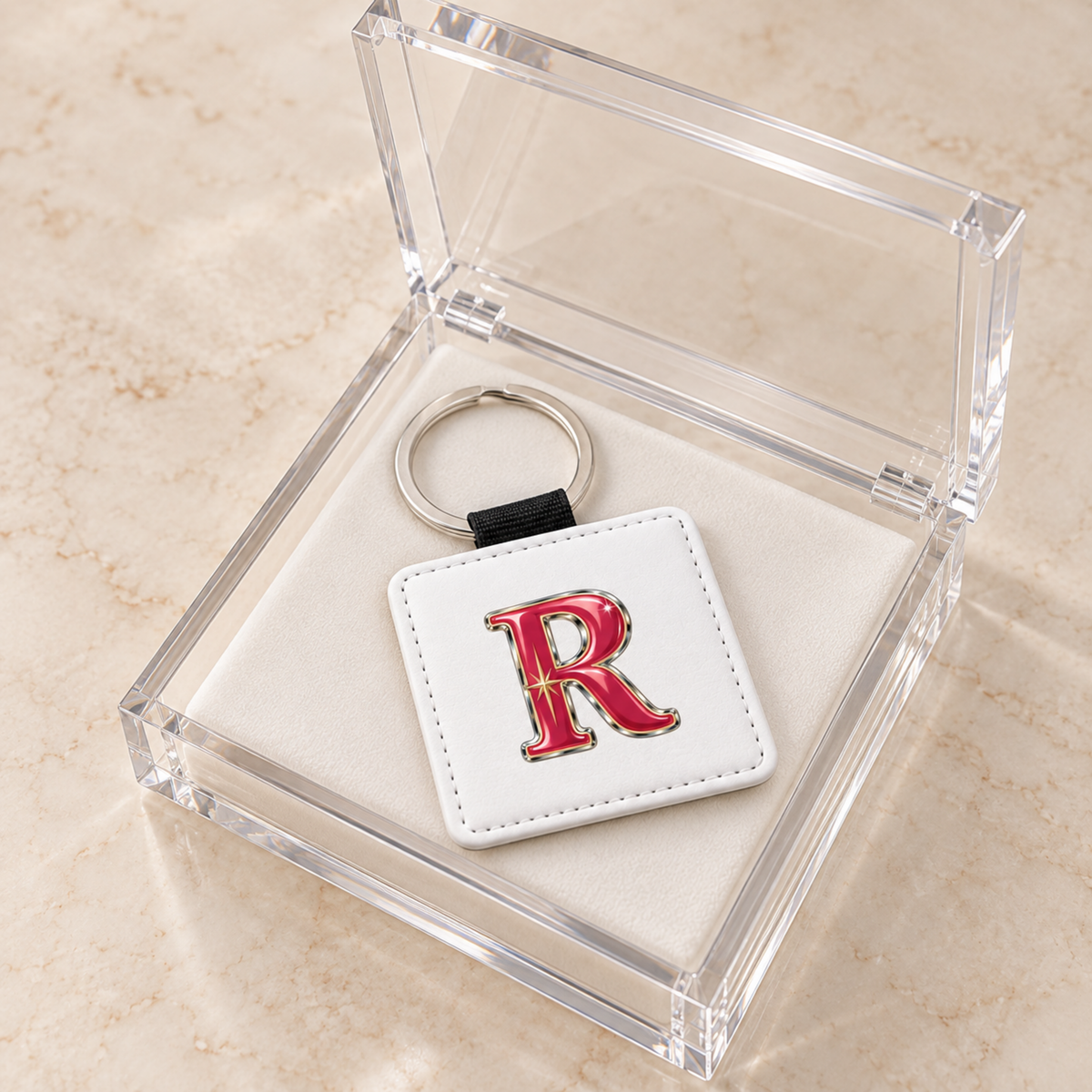 Stardust Enamel Personalized Monogram Keychain | Chrome & Starlight: a square white stardust enamel keychain featuring a red, chrome-outlined letter R in a clear acrylic gift box.