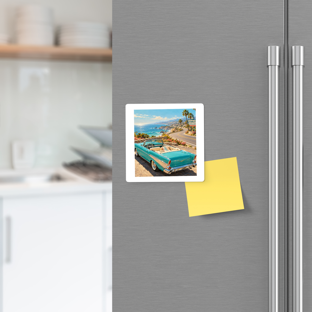 A square The Road Opens Magnet | Chrome & Starlight coastal refrigerator magnet showing a teal convertible driving along a highway, placed next to a blank yellow sticky note on a stainless steel fridge.