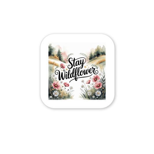 The Stay Wildflower Magnet by Mirabilia Boutique features "Stay Wildflower" in black script over pastel wildflowers and trees. This floral magnet with a white border adds a meadowcore touch to your fridge or locker.