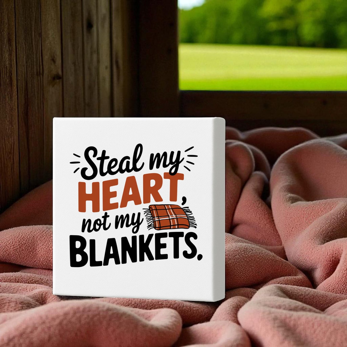 Create a cozy bedroom with the Mirabilia Boutique "Steal My Heart Not My Blankets" Funny 8x8 Canvas Sign. Featuring a plaid blanket drawing, this charming decor makes a perfect gift for couples or a playful touch to your space.