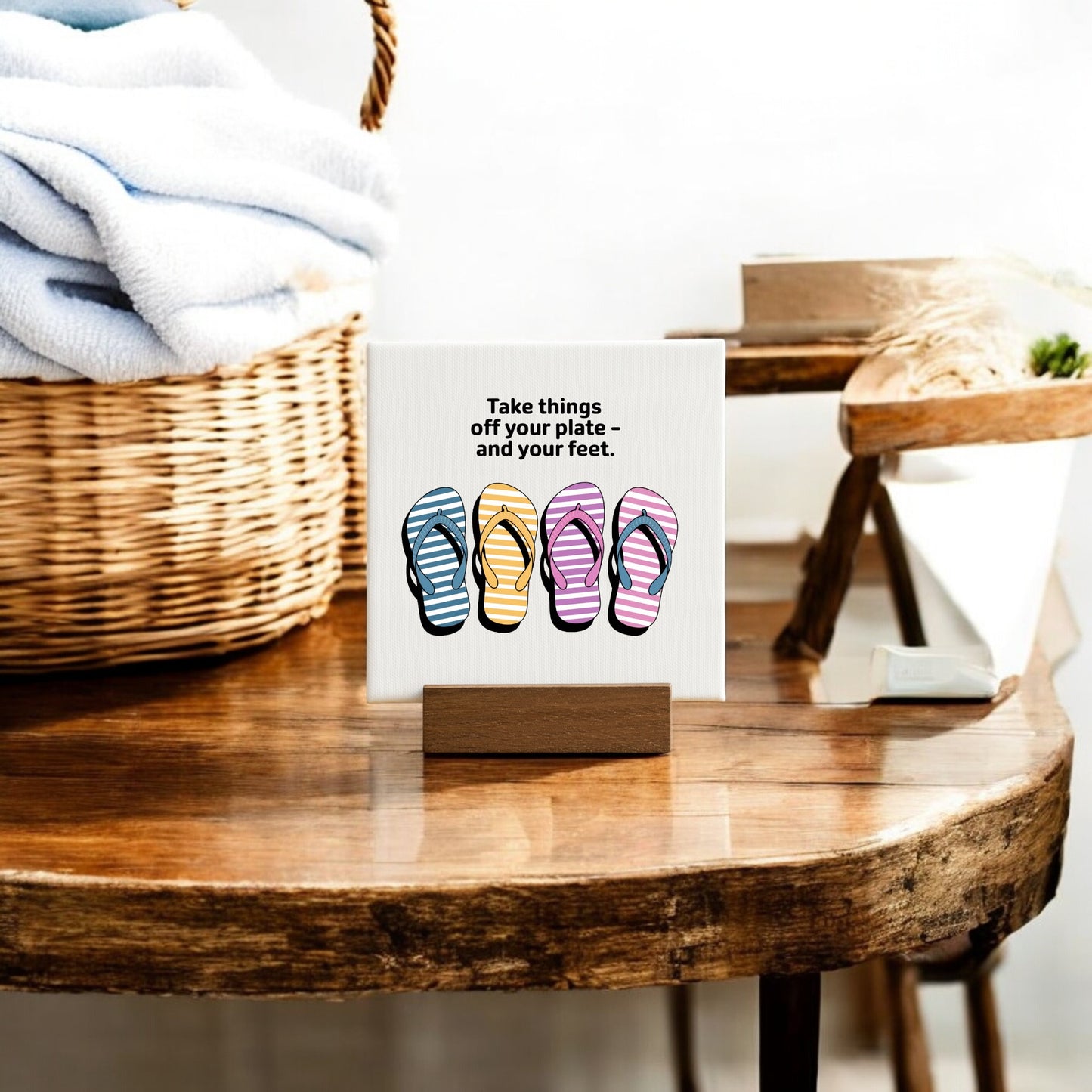 The Mirabilia Boutique "Take Things Off Your Feet" Mini Canvas (4x4) features flip-flop art and comes with a stand—perfect as cheerful summer decor on a table, next to towels or a plant.