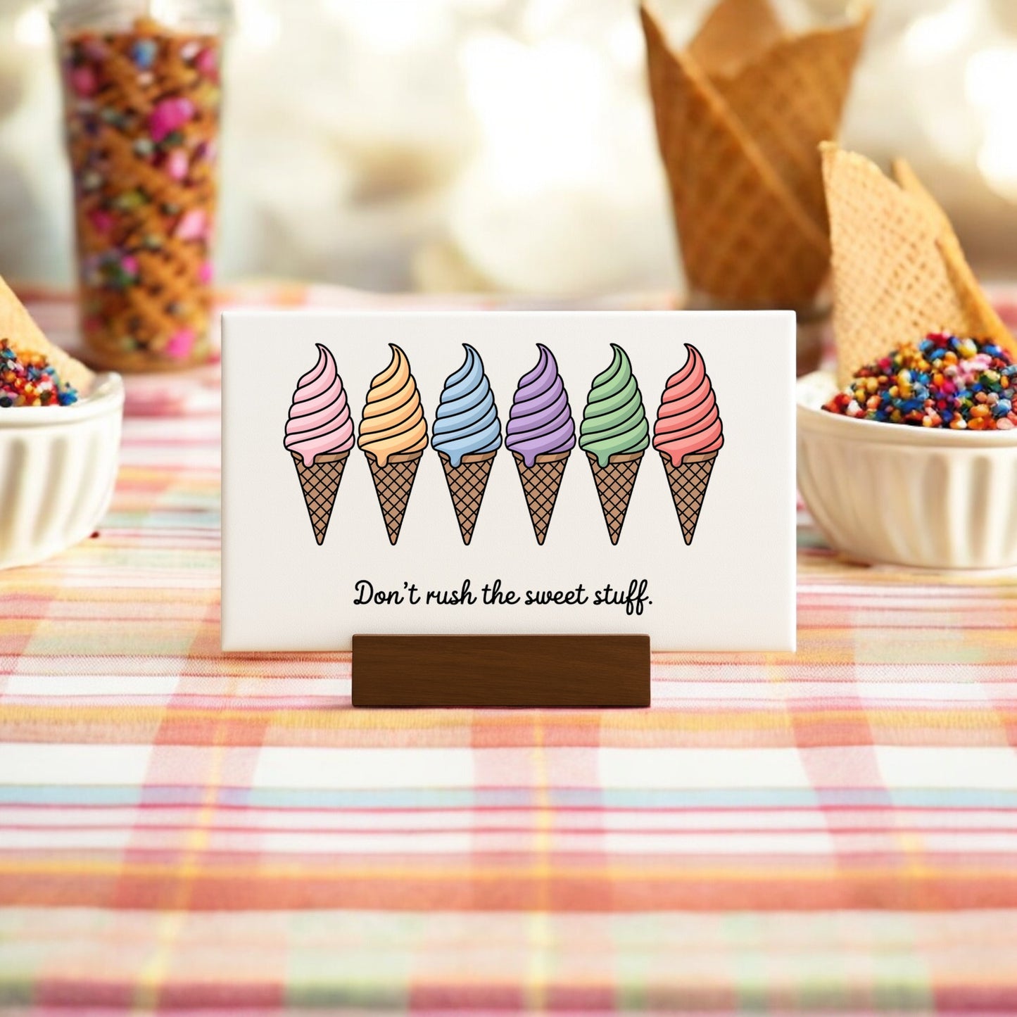 The Don’t Rush the Sweet Stuff – Canvas Ice Cream Sign by Mirabilia Boutique displays six pastel ice cream cones in a row above its message, evoking charming ice cream art that's perfect for brightening any space.
