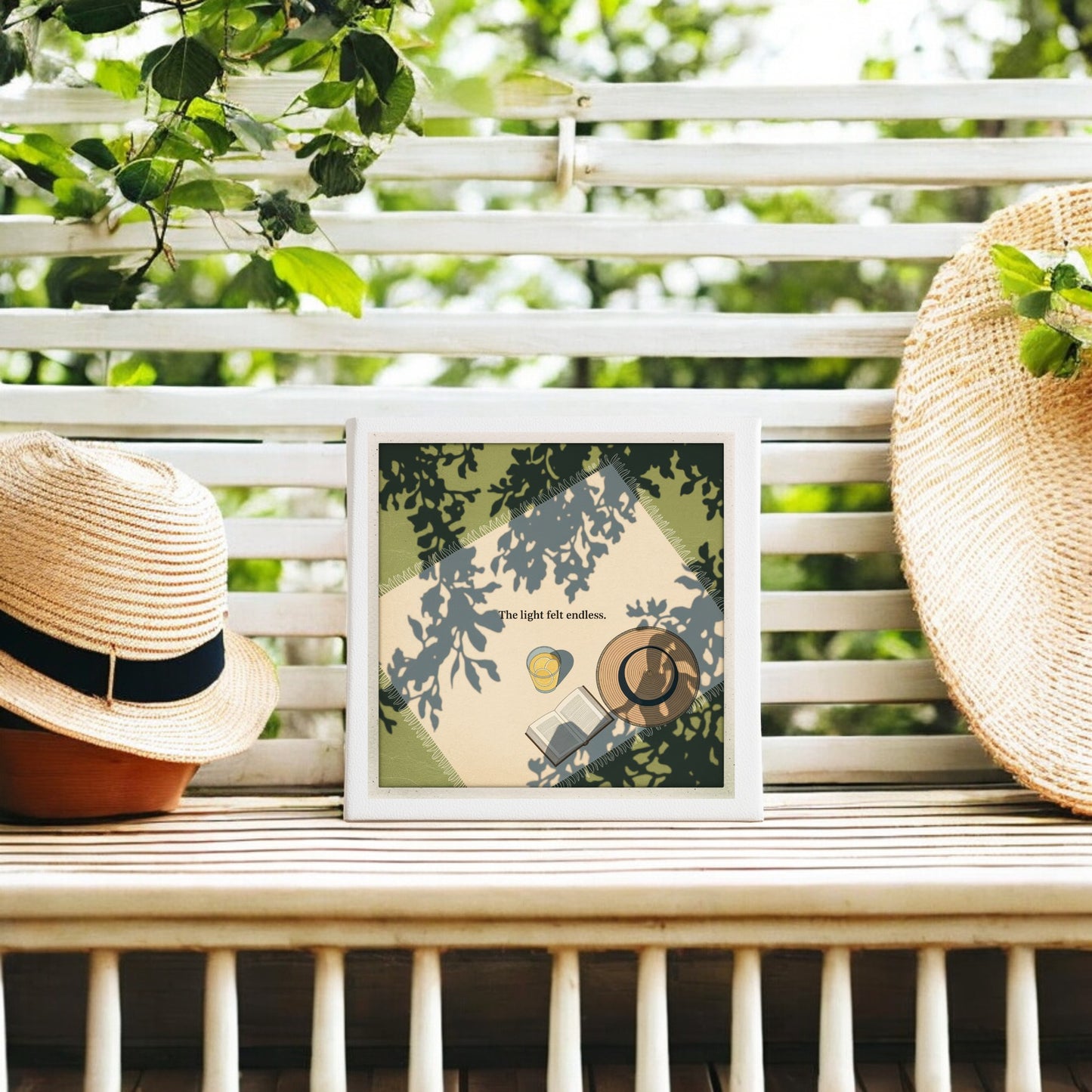 The Light Felt Endless Canvas – Summer Stillness Art by Mirabilia Boutique sits on a slatted outdoor bench with two straw hats. Sunlight through leafy branches casts dappled shadows, embodying slow living in this artful scene.