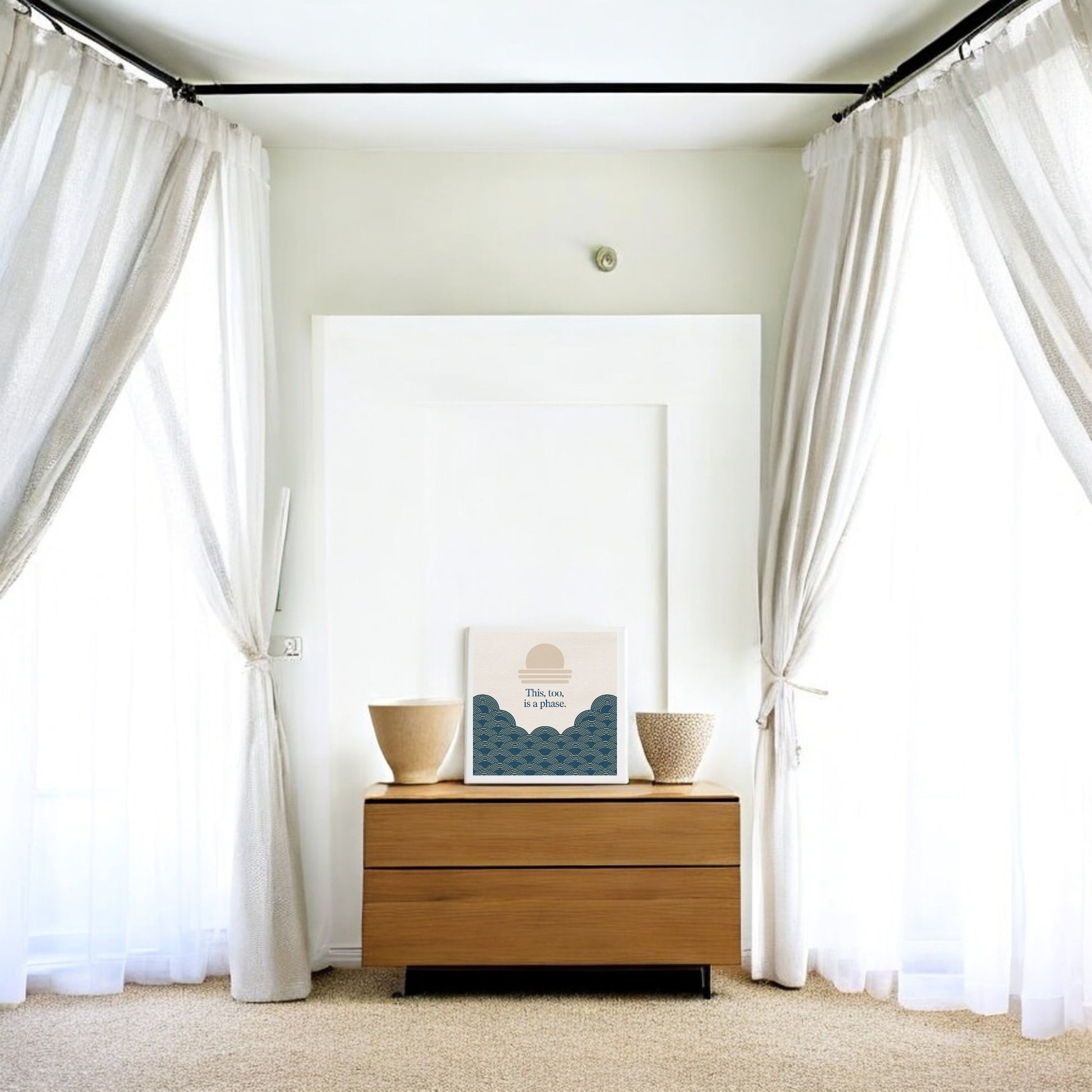 A minimalist room with sheer white curtains, light wood dresser, woven baskets, and calming wall decor—a Mirabilia Boutique “This Too Is a Phase” Canvas featuring blue waves, a sun, and uplifting art.