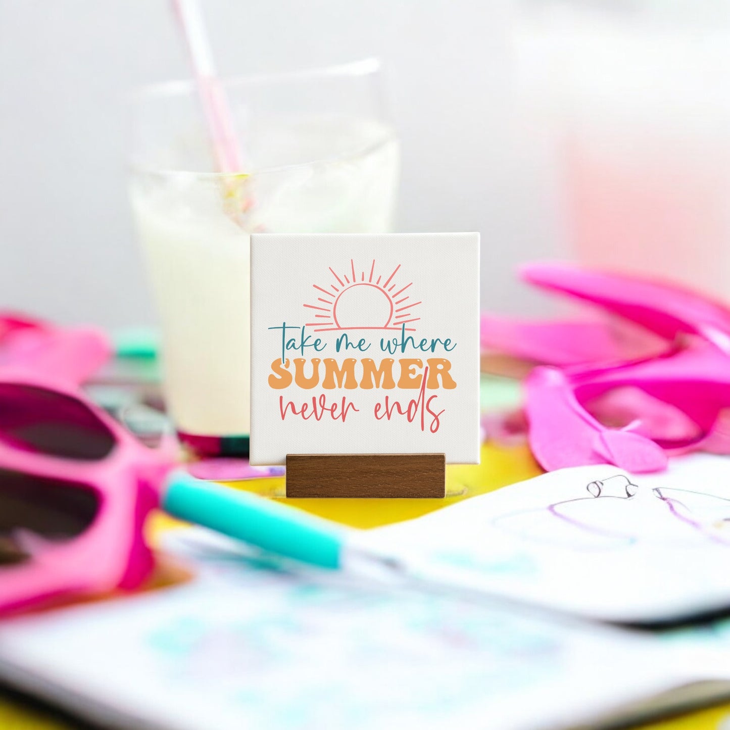 The Mirabilia Boutique "Take Me Where Summer Never Ends" Mini Canvas features colorful text, perfect for playful summer decor or as a fun beach house accent. Set it on a table for a vibrant seasonal touch.