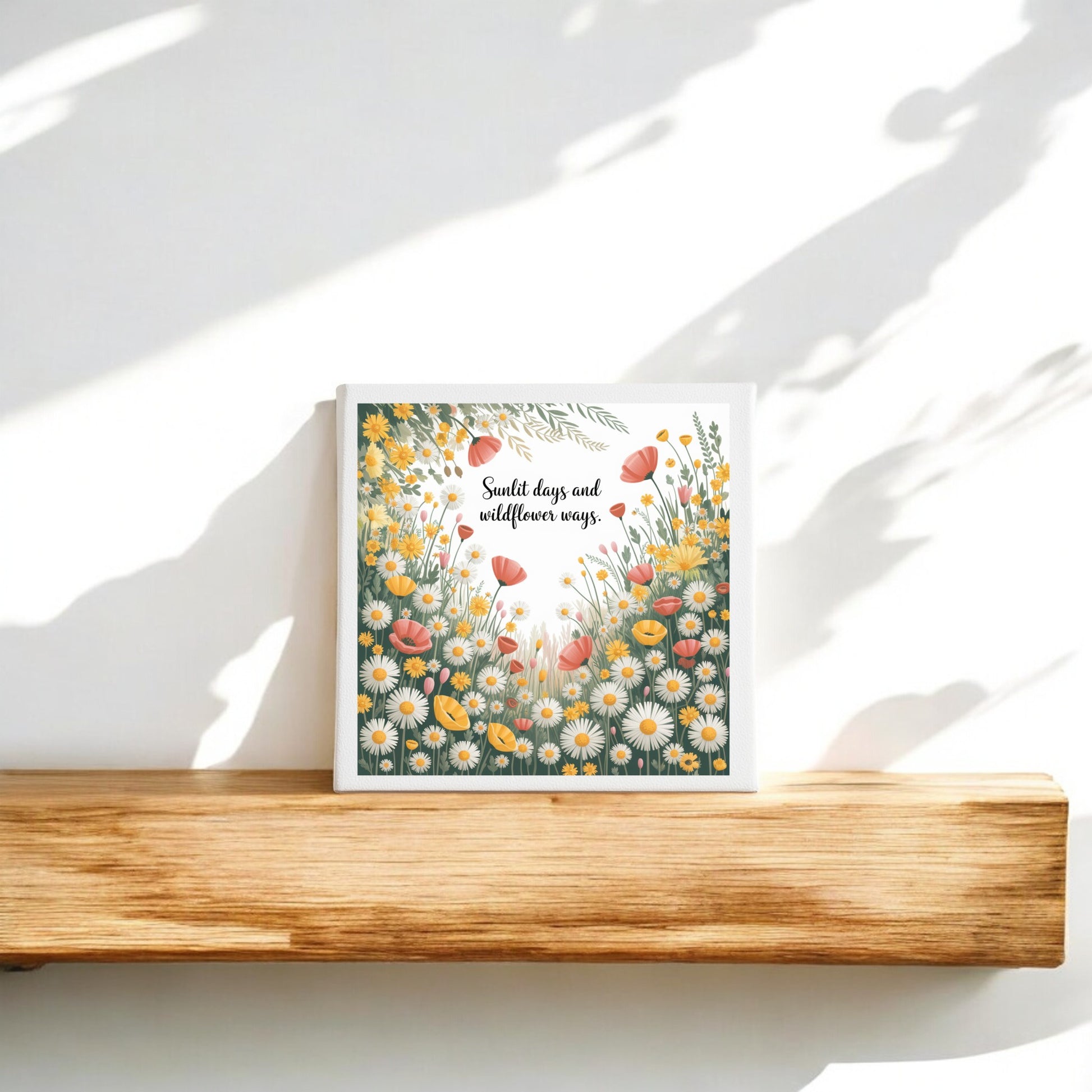 The Sunlit Days and Wildflower Ways Canvas – 8x8 Floral Art by Mirabilia Boutique features a charming floral design and uplifting text, adding cottagecore style to your space as sunlight casts soft shadows across your wall.