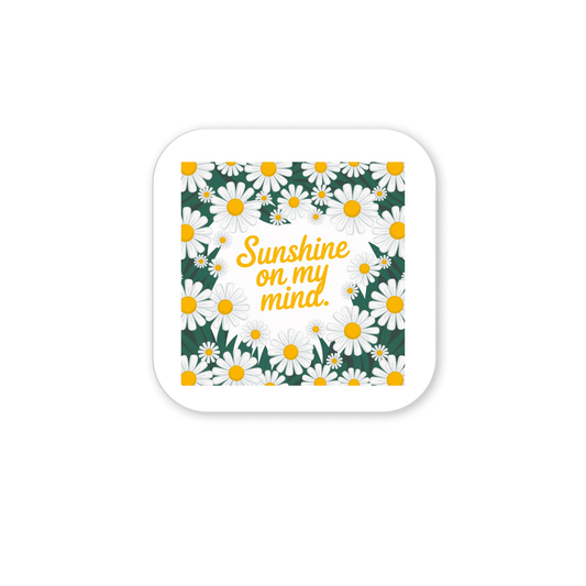 Brighten your space with the Sunshine on My Mind Magnet from Mirabilia Boutique, featuring cheerful white daisies and yellow text on a white background—perfect floral fridge art for any room.