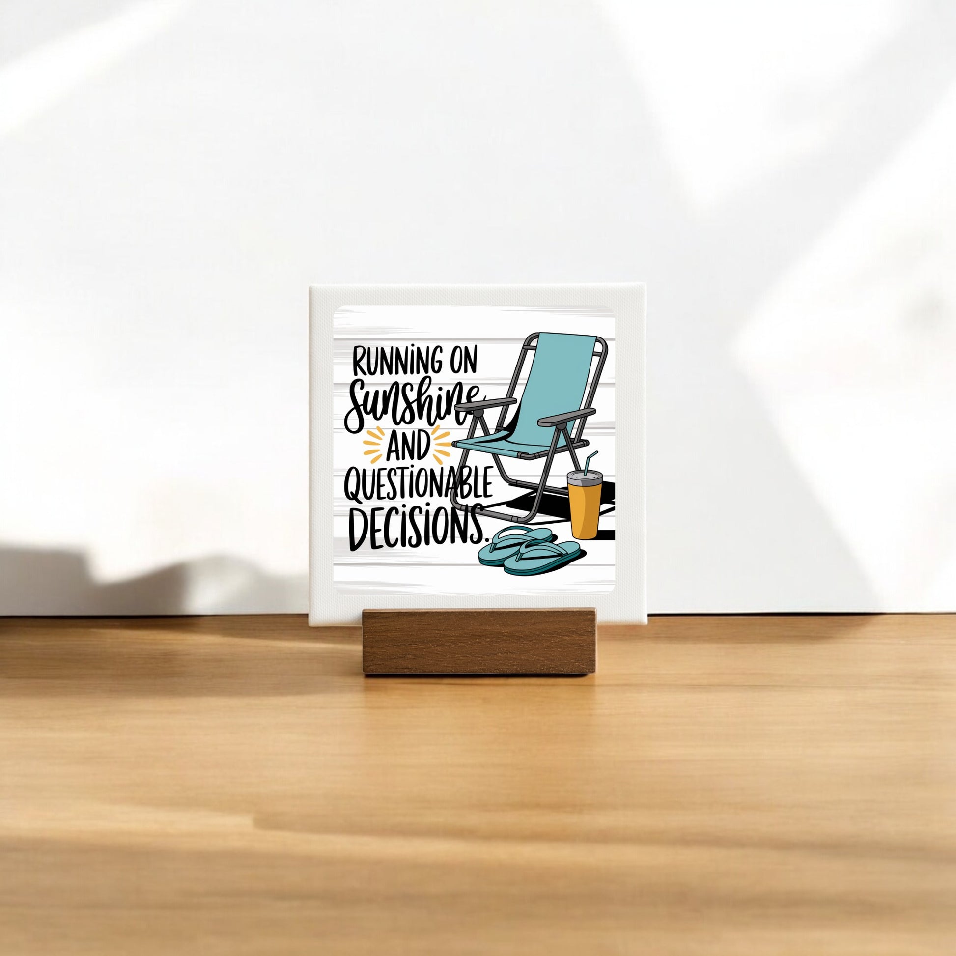 The Running on Sunshine Mini Canvas (4x4) by Mirabilia Boutique features a lounge chair, sunglasses, and drink with the phrase "Running on sunshine and questionable decisions." A fun summer sign perfect for poolside decor.