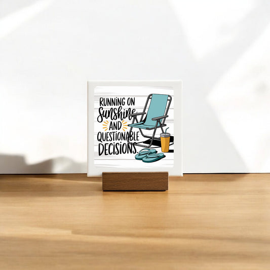 The Running on Sunshine Mini Canvas (4x4) by Mirabilia Boutique features a lounge chair, sunglasses, and drink with the phrase "Running on sunshine and questionable decisions." A fun summer sign perfect for poolside decor.