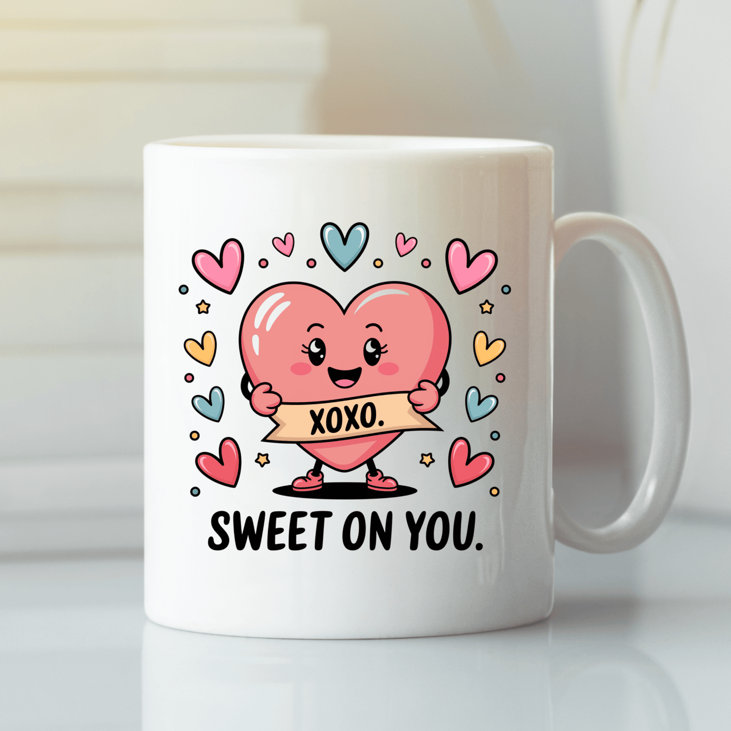 The Sweet On You Heart Mug by Mirabilia Boutique features a cute pink heart with an "XOXO" banner, surrounded by colorful hearts and stars, plus "SWEET ON YOU" text—making it the perfect cute Valentine’s gift for someone special.